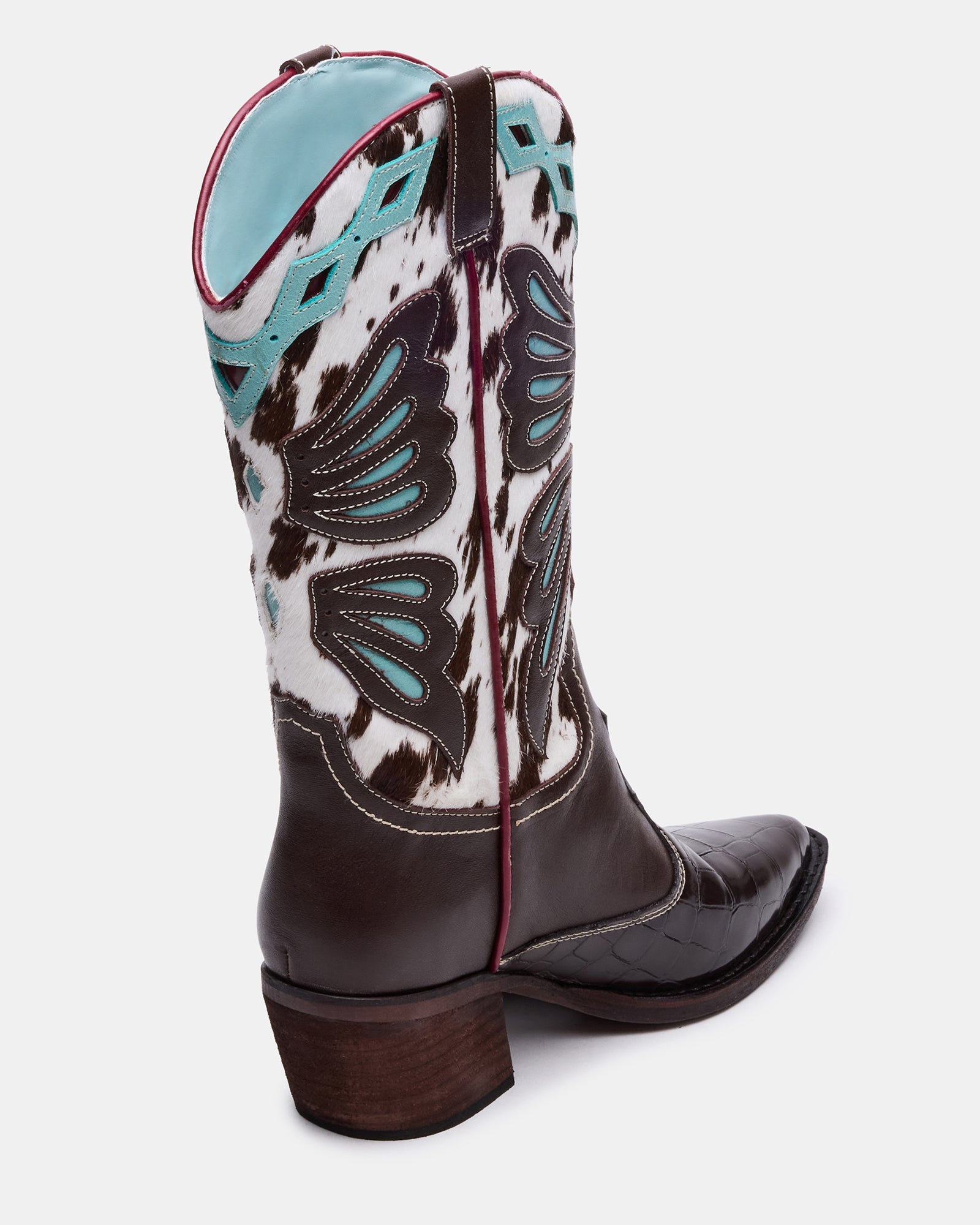 Close-up of black pointed toe boots showing multi-tone leather finish
