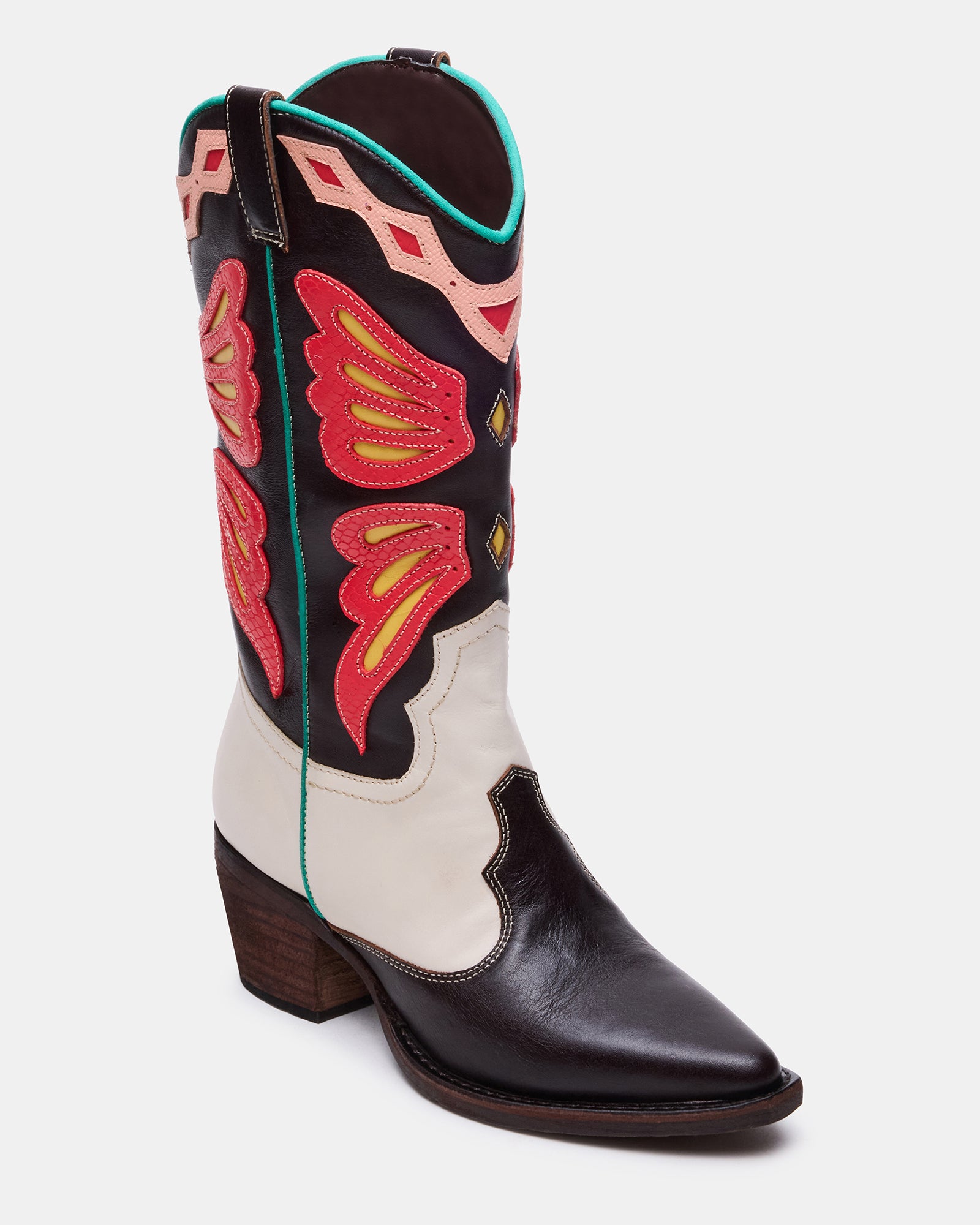 Woman wearing black western boots with a dress at a casual event.