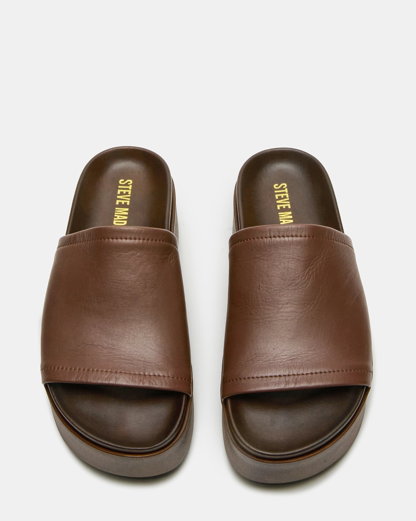 Close-up of the chunky footbed on Arwens brown platform sandals, highlighting comfort.