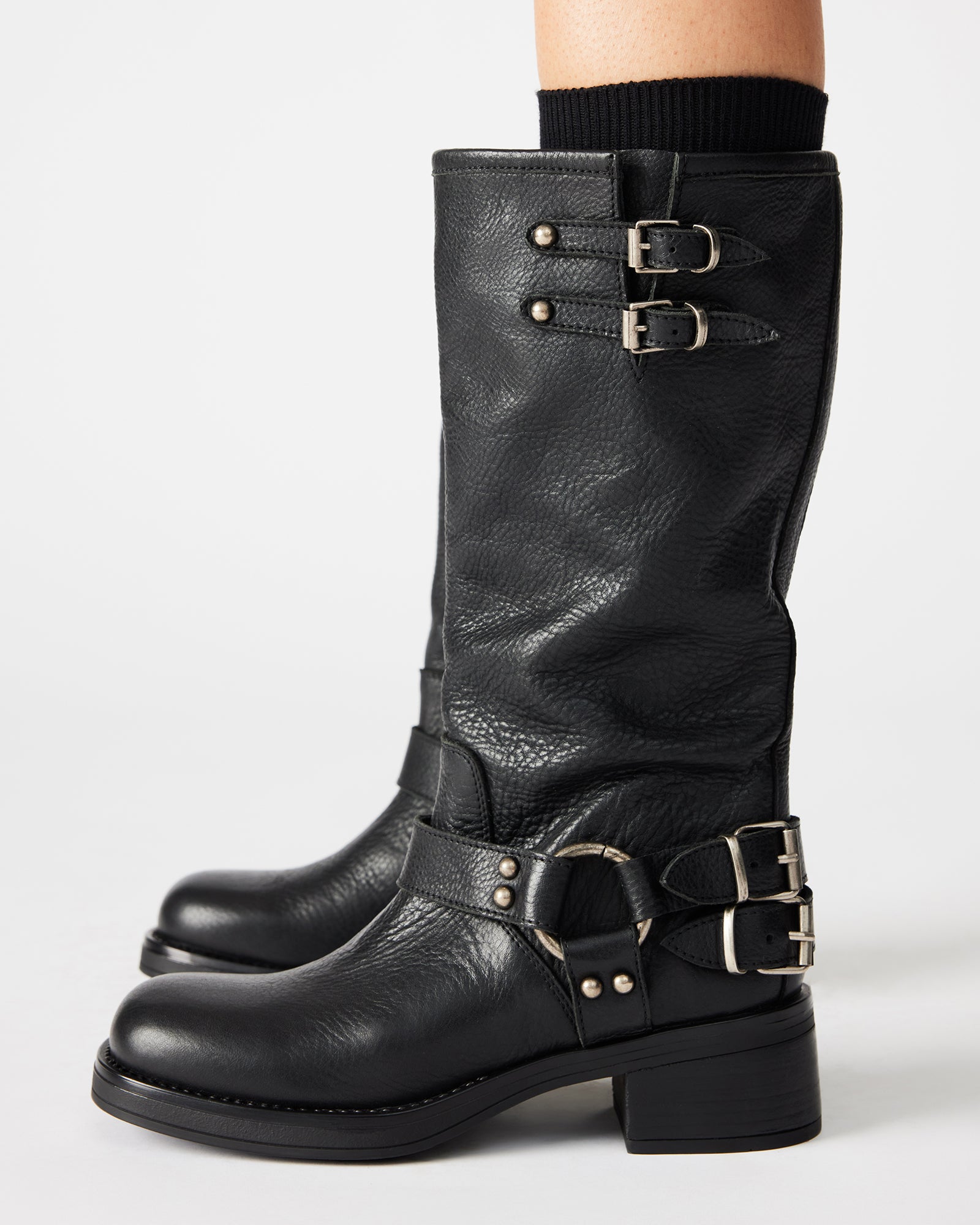 Close-up of strap hardware and heel of black leather engineer boots