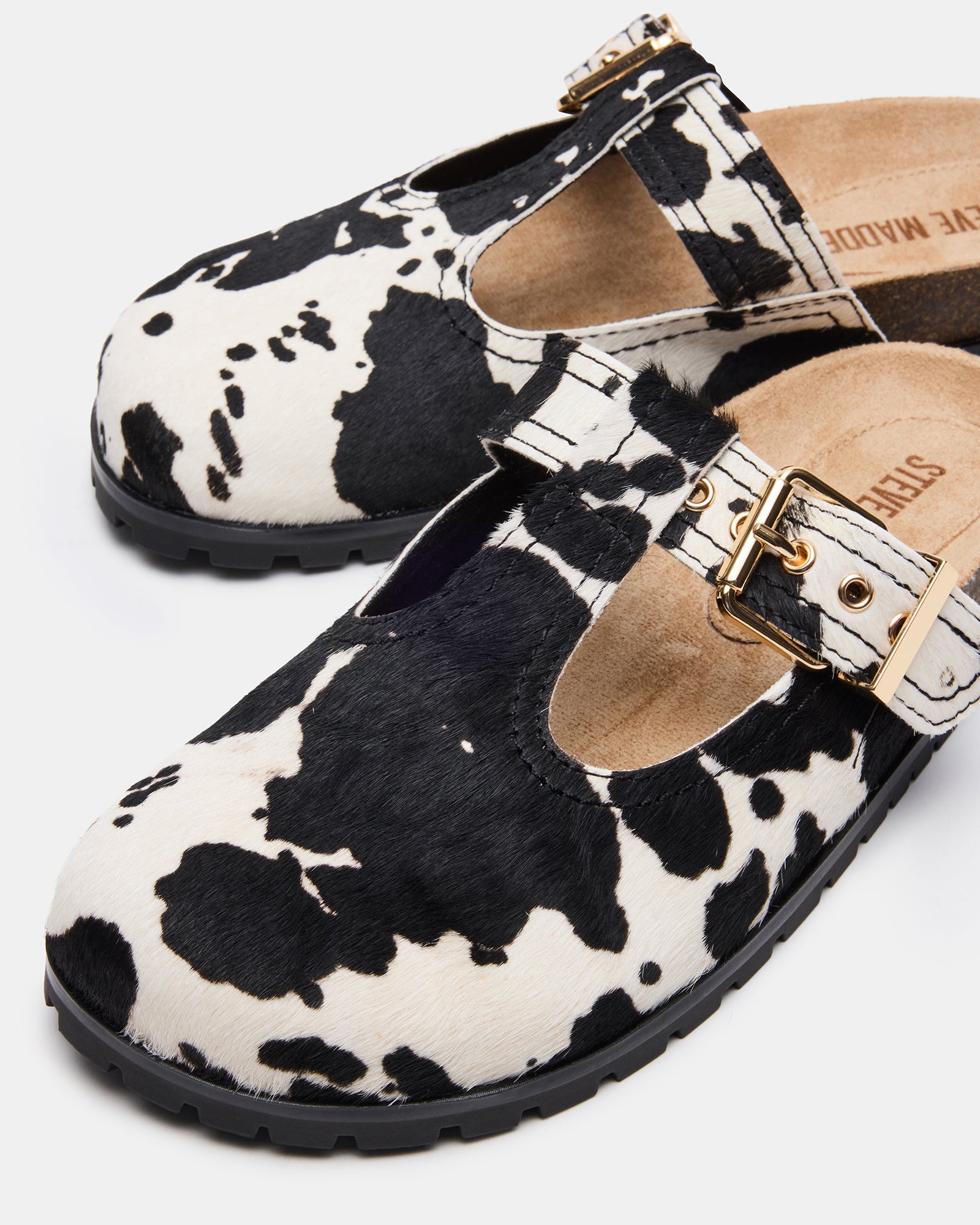 Close-up of suede texture and microsuede sock of the black leather mules