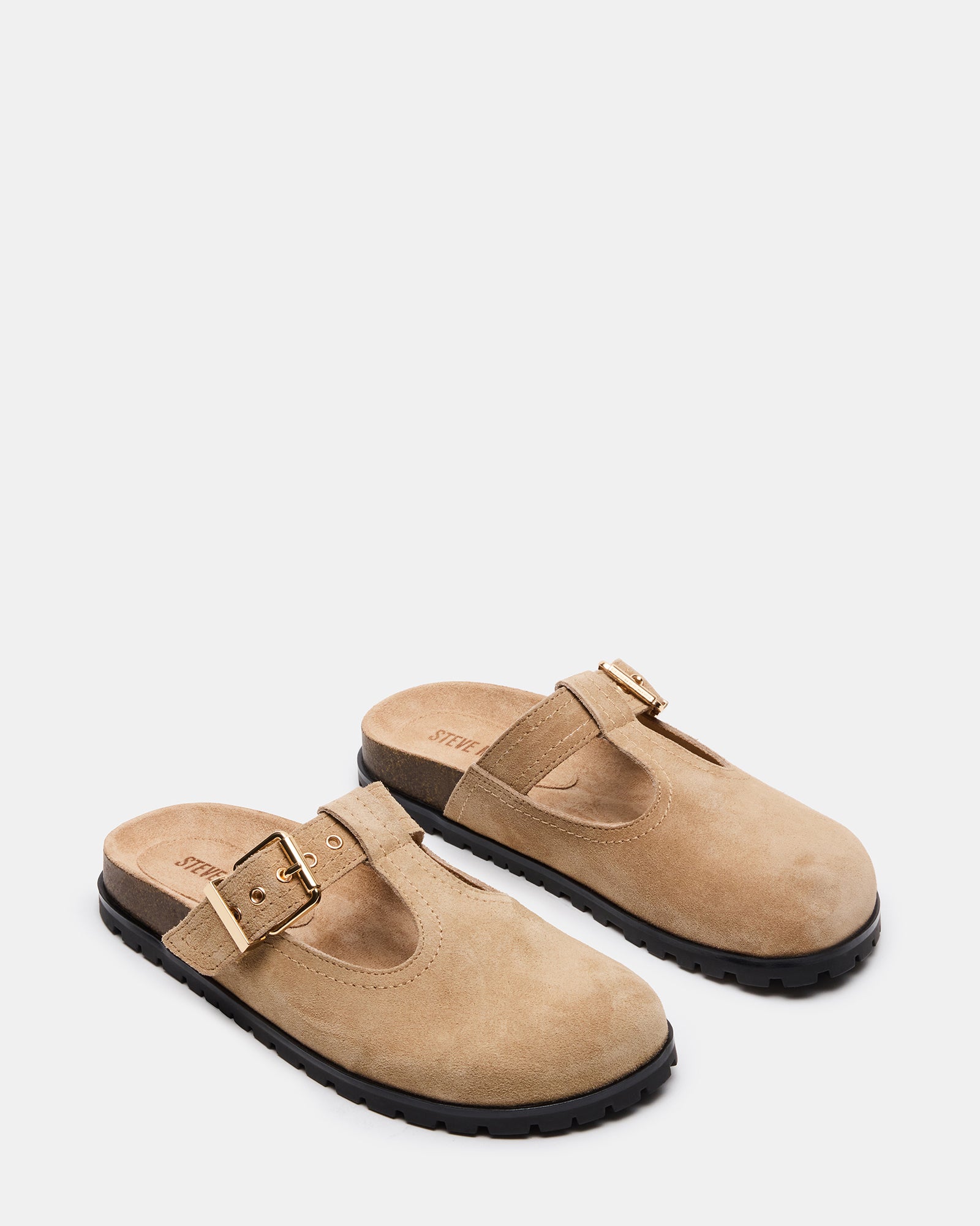 Side view of Atticus Taupe suede mules highlighting the 1-inch heel and elegant design.