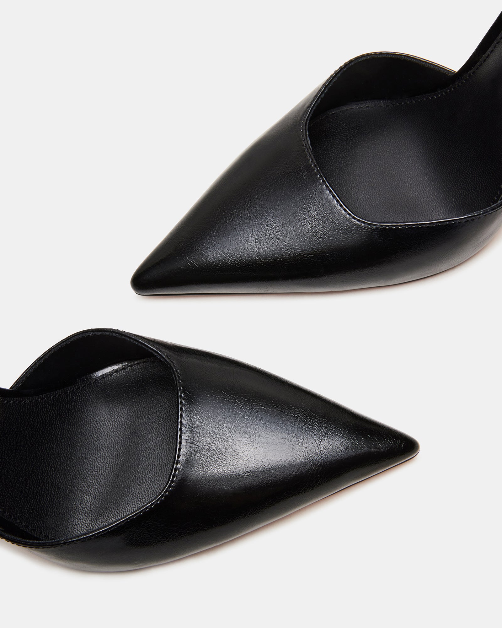 Close-up of the gold ankle strap on the pointed toe pumps.