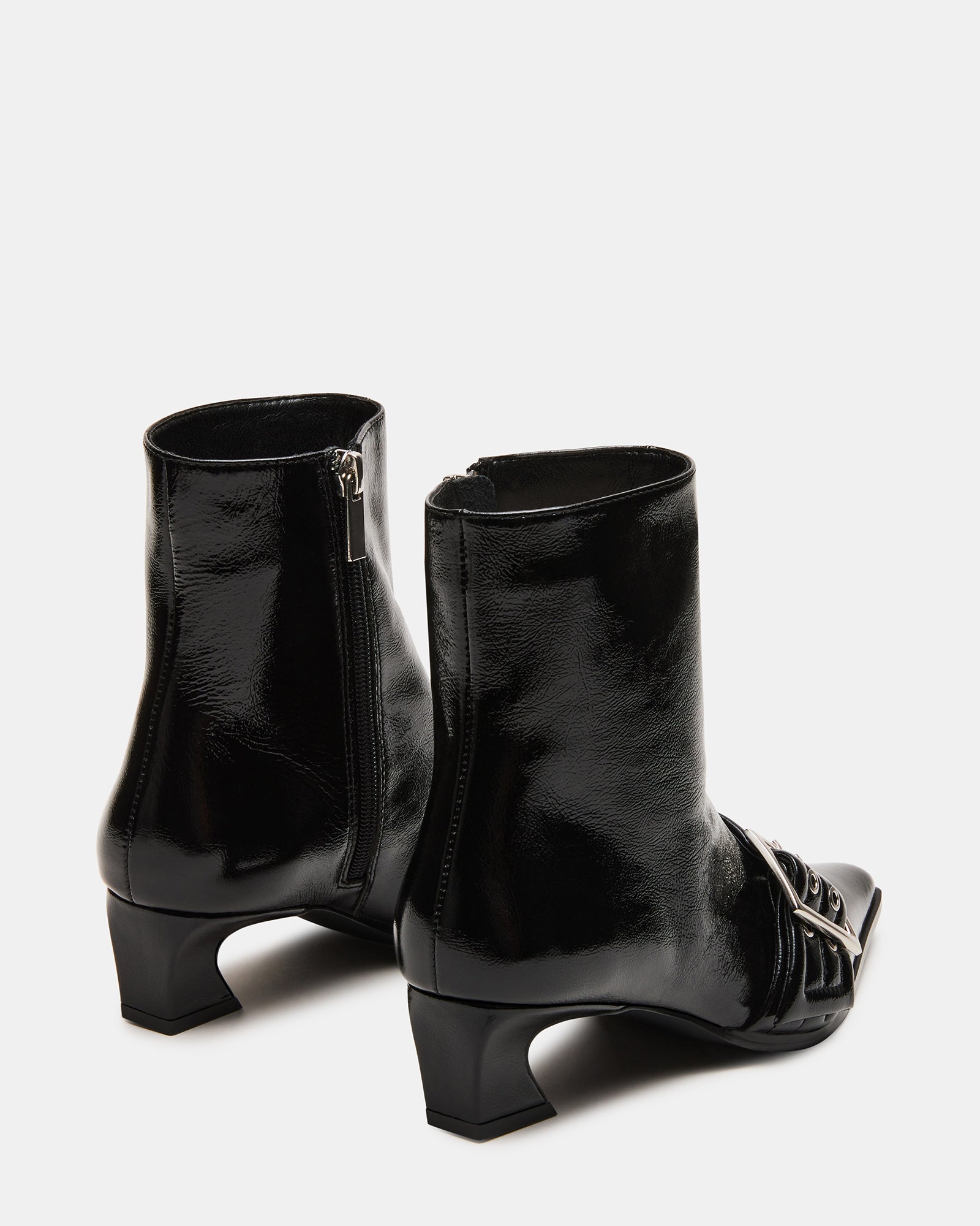 Woman walking in urban setting wearing AXTON womens ankle boots