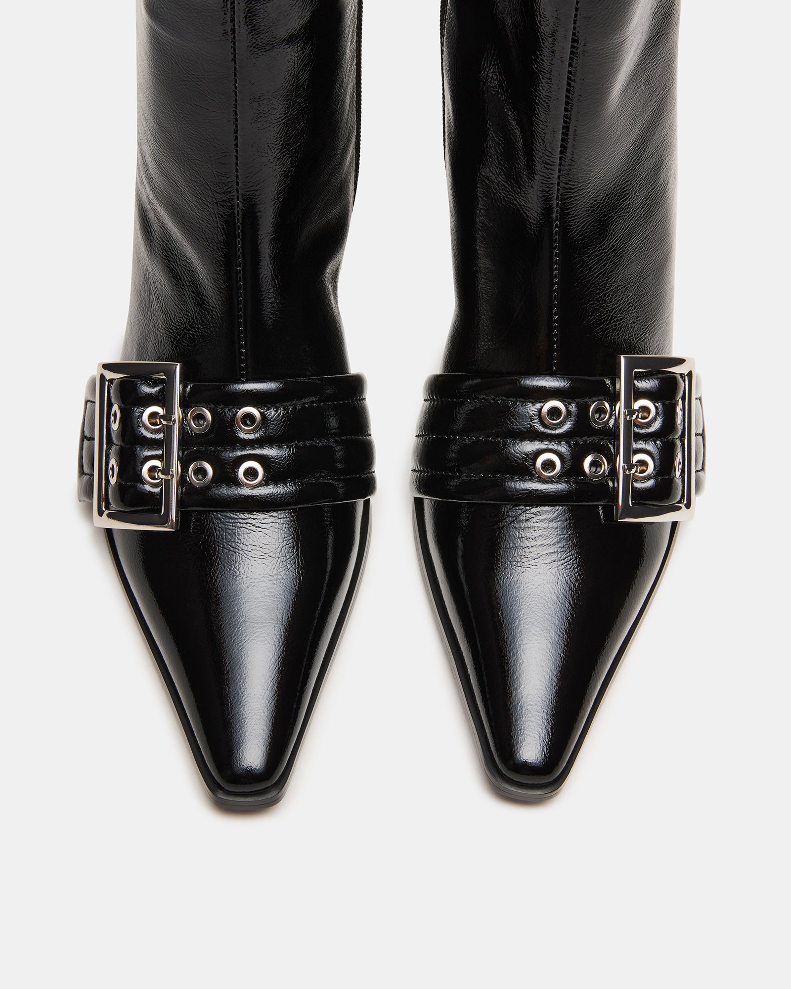 Front angle showing the pointed toe and buckle accents on these leather booties