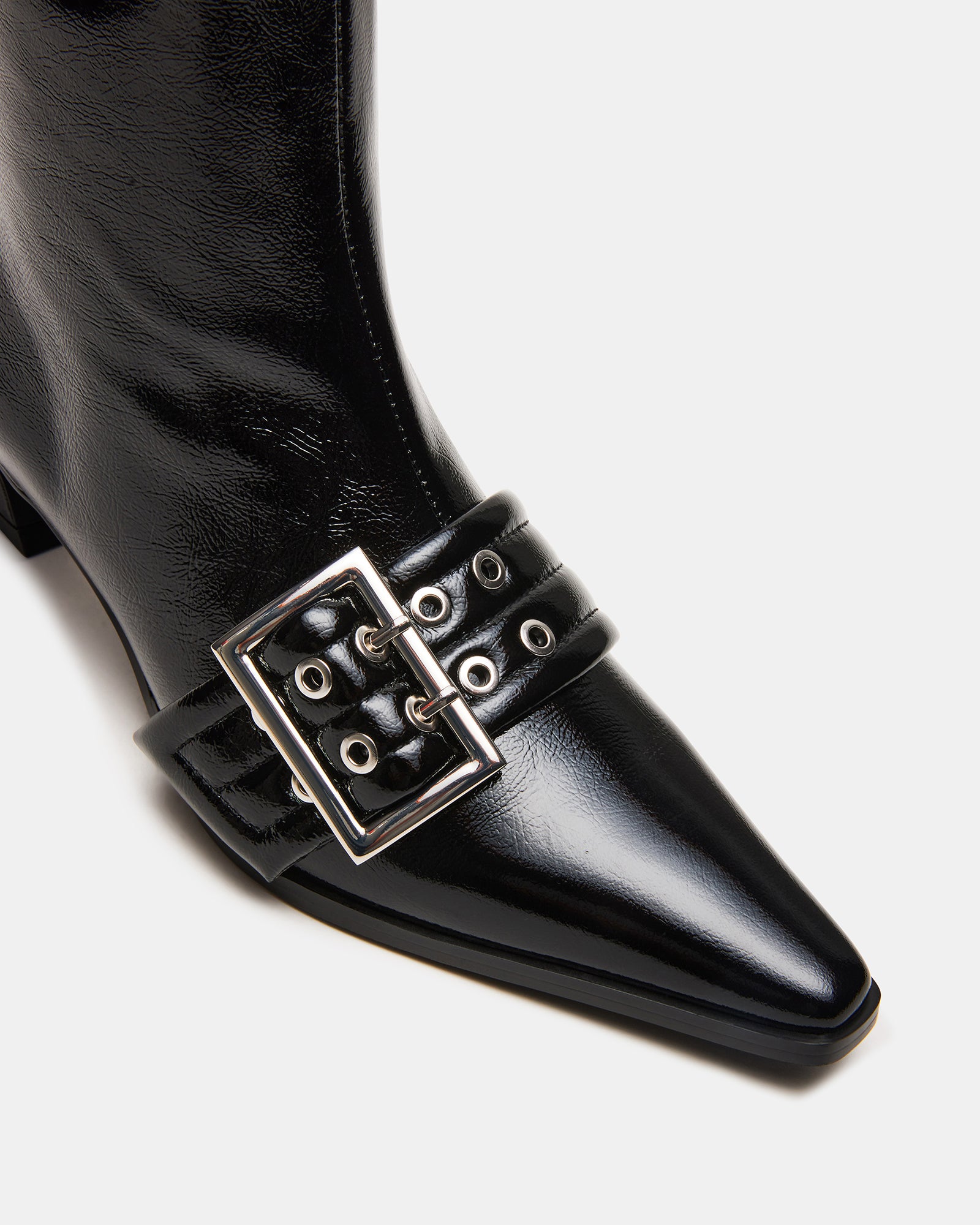 Side view of AXTON black ankle boots styled with skinny jeans