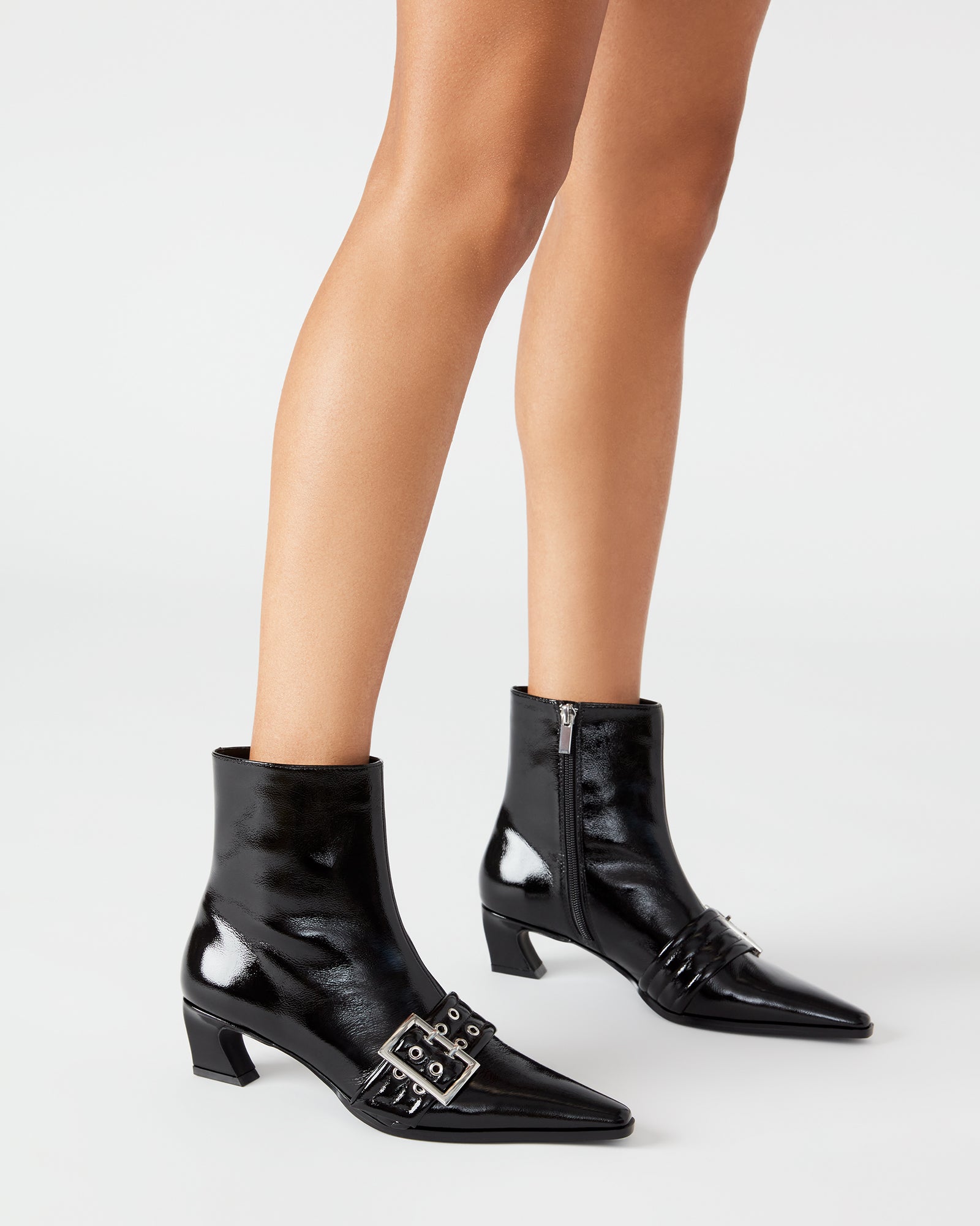 Front angle showing the pointed toe and buckle accents on these leather booties
