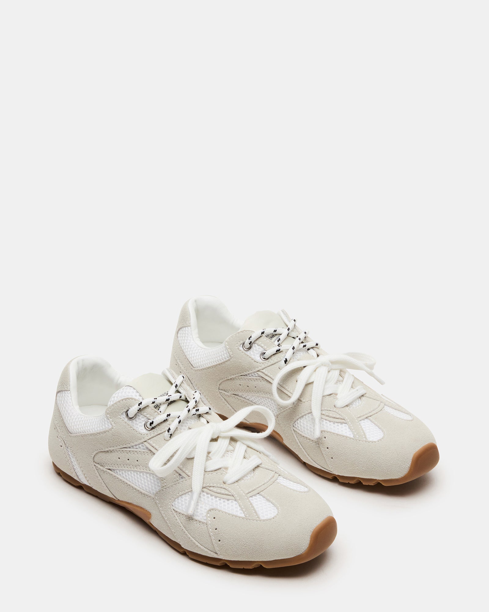 Close-up of the soft suede upper of Aziel white sneakers.
