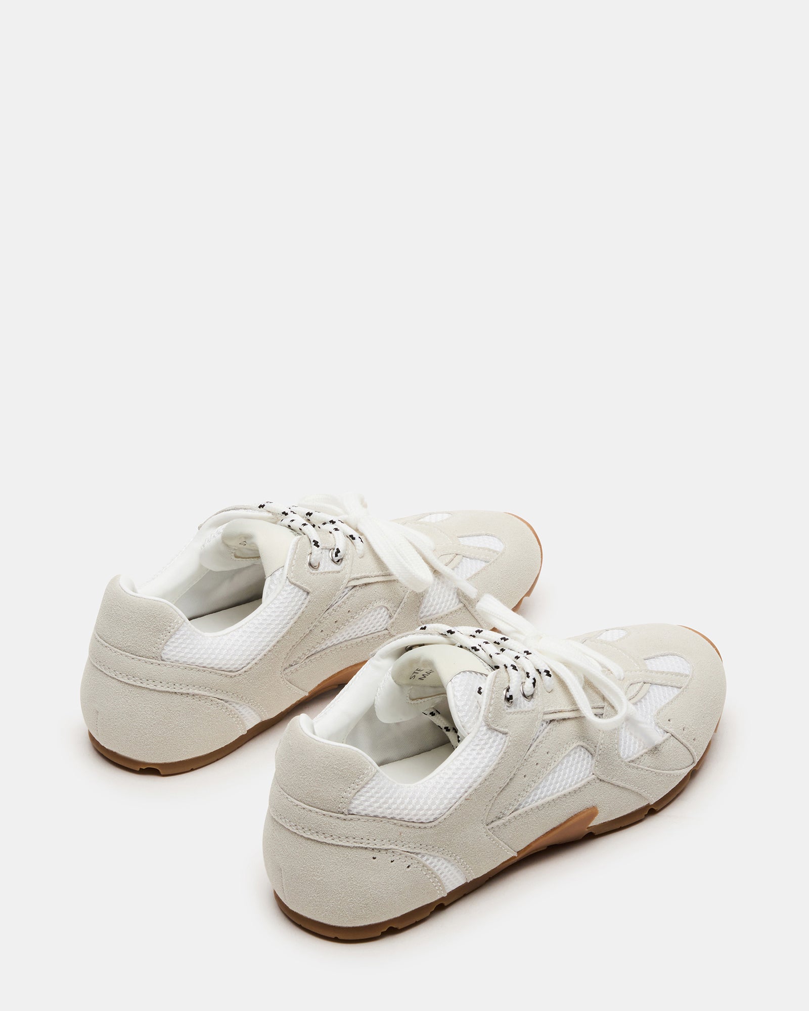 Close-up of the soft suede upper of Aziel white sneakers.