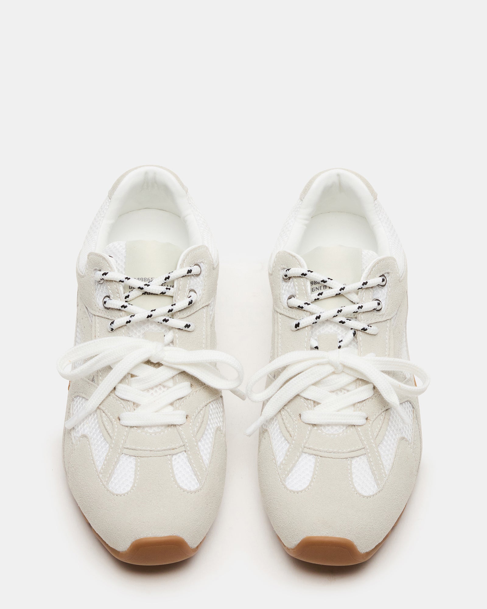 Aziel white suede sneakers from the side, highlighting the lace-up feature.
