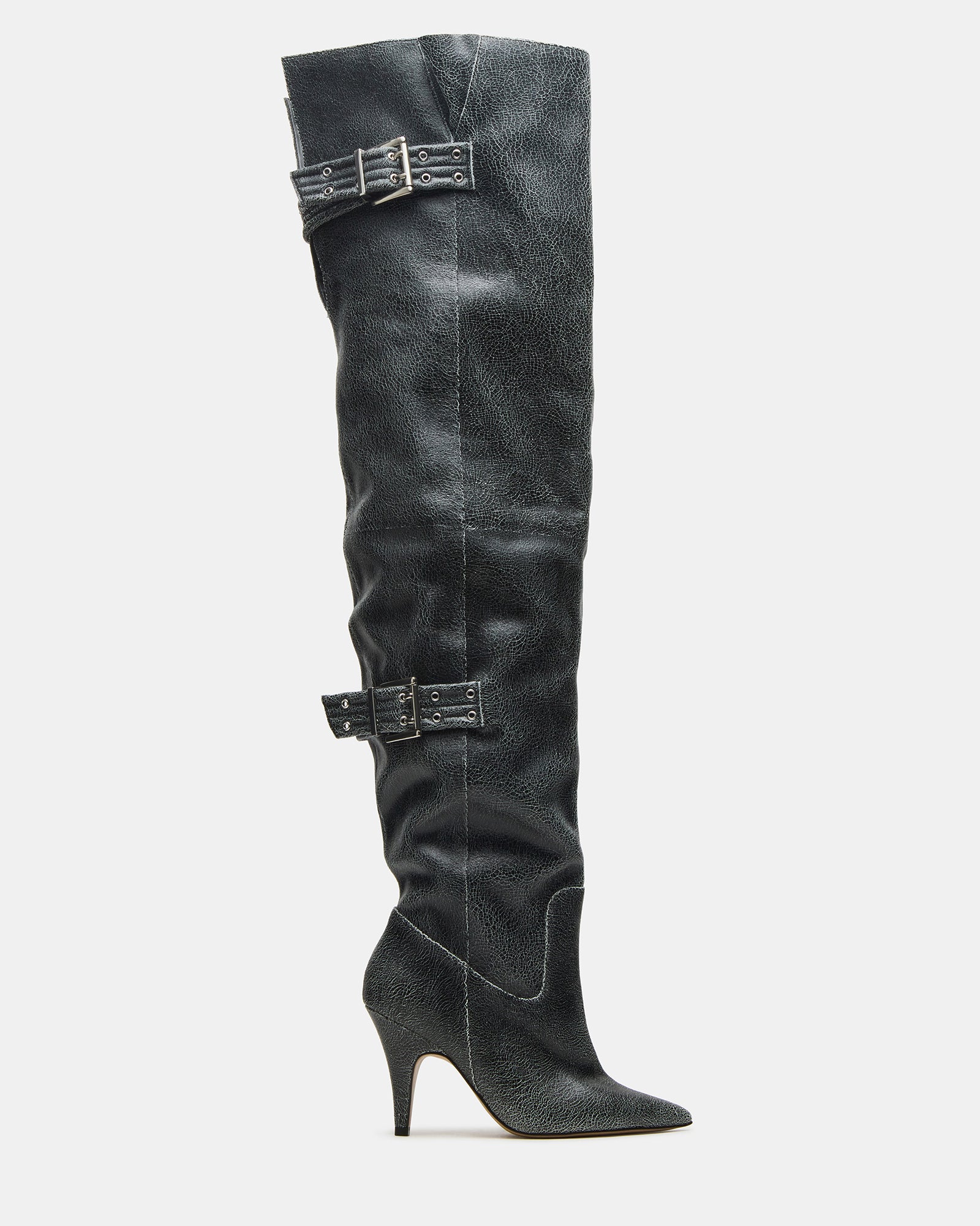 Side view of black distressed over-the-knee boots with pointed toe and buckle