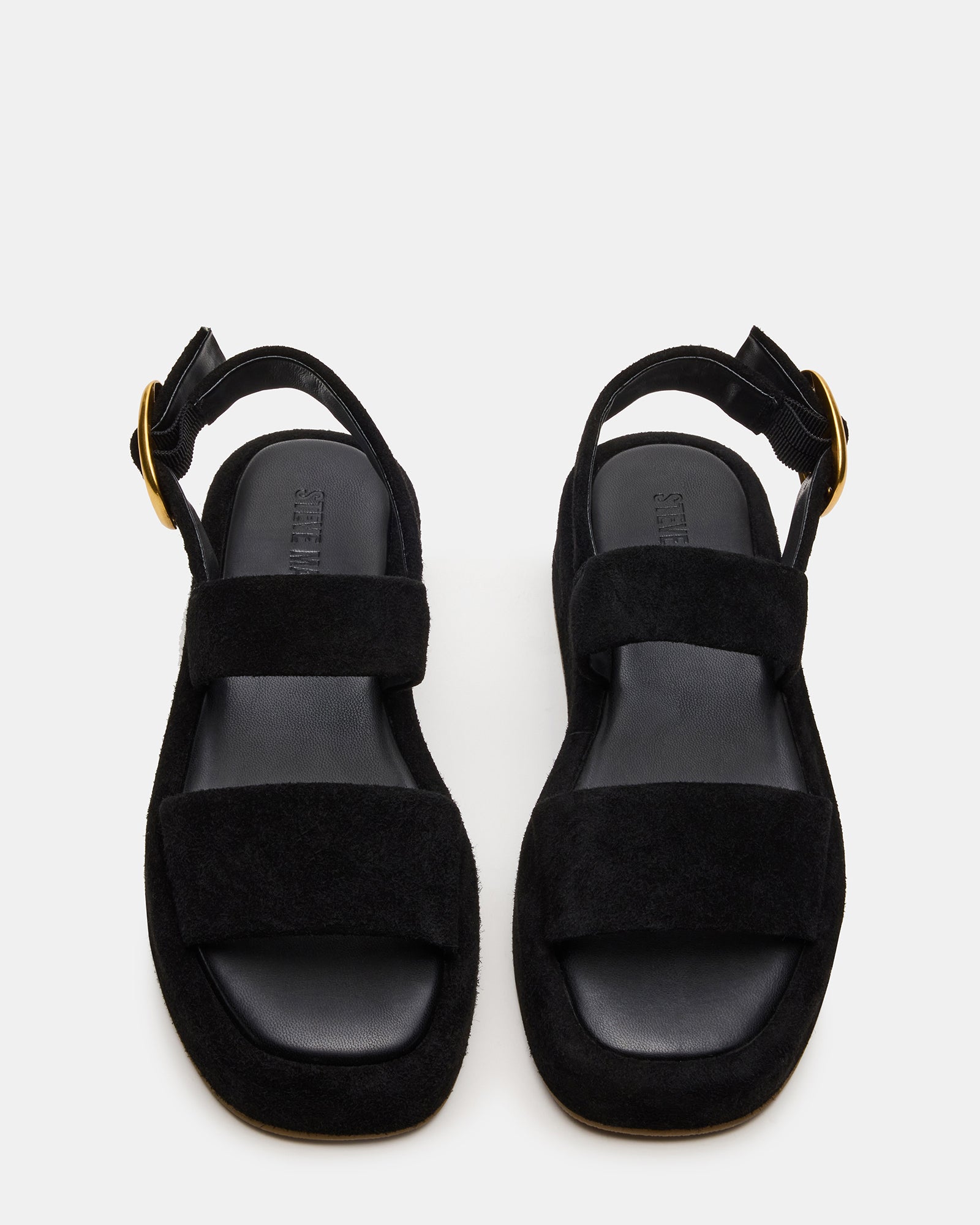 Black suede sandals styled with summer outfit for a chic look.