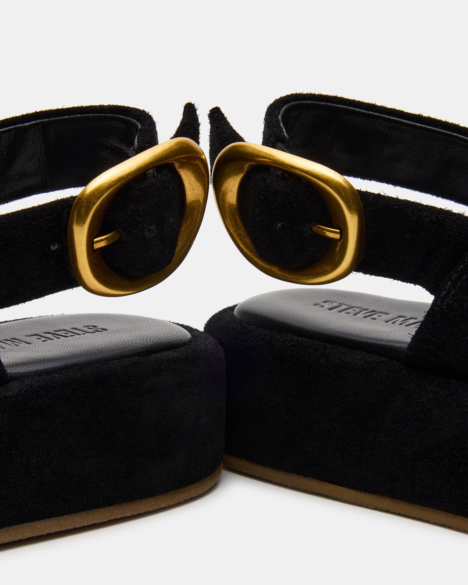 Side view of black platform sandals showcasing square toe design.