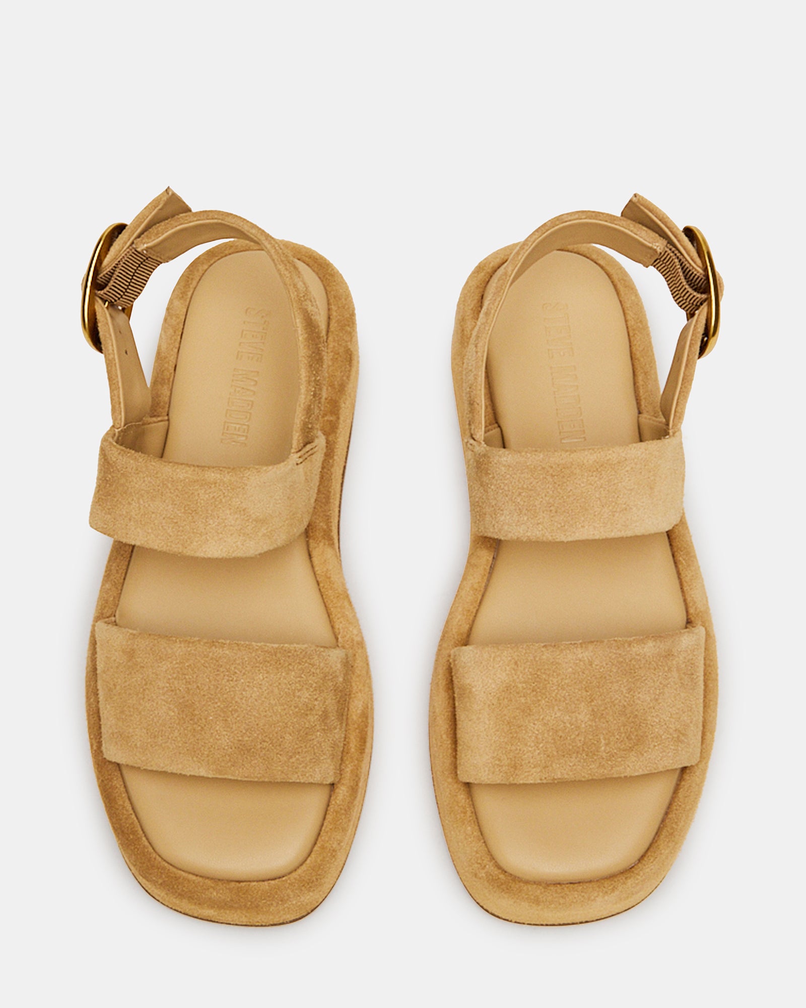 Close-up of black platform sandals highlighting the suede upper material.