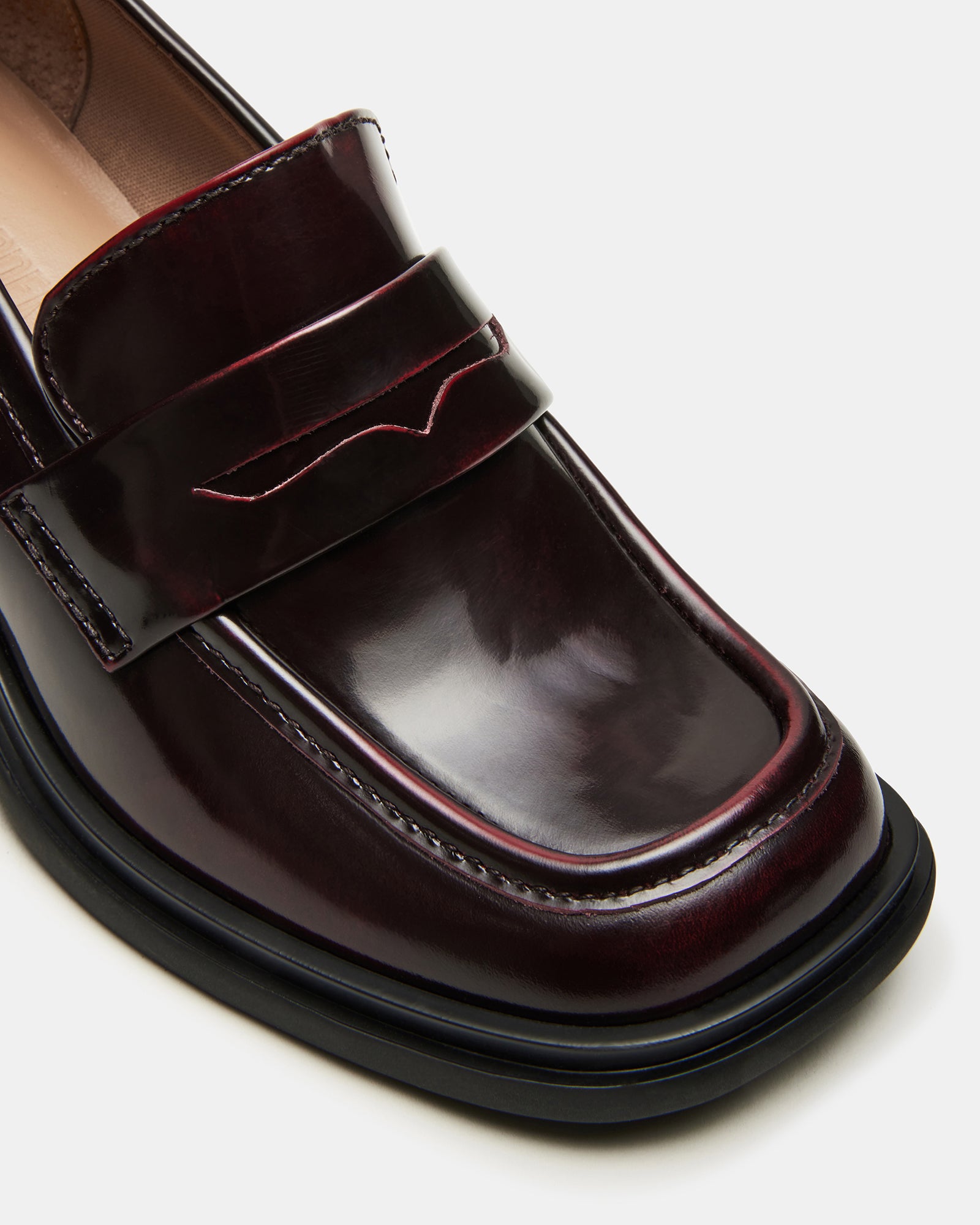 Woman wearing Baxter Burgundy loafers with tailored trousers