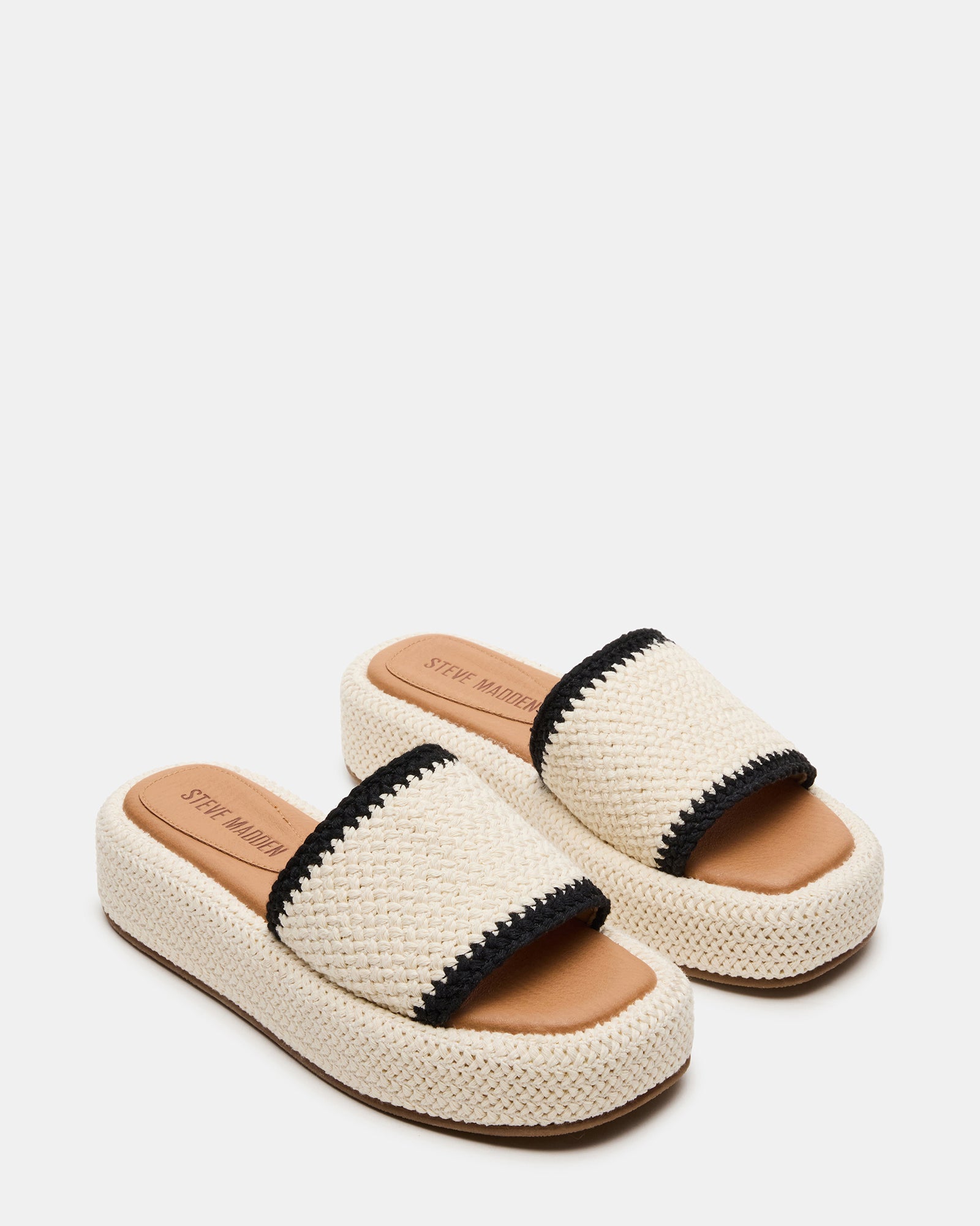 Side view of women wearing cream multi square toe flatform sandals during a summer walk