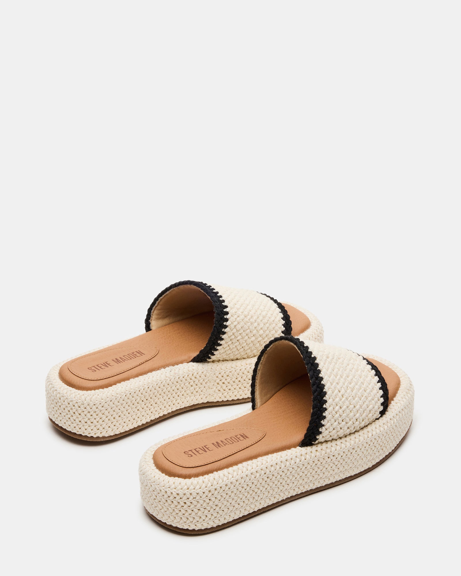 Side view of women wearing cream multi square toe flatform sandals during a summer walk