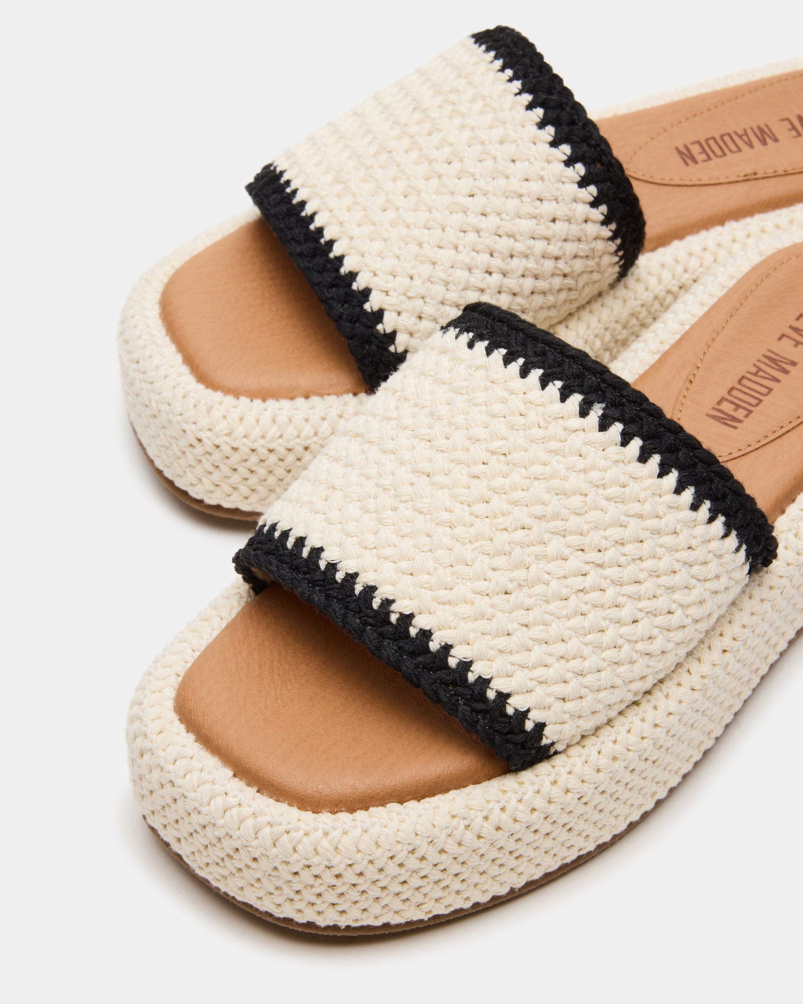 Footwear detail highlighting the 1.5-inch flatform heel and slip-on design