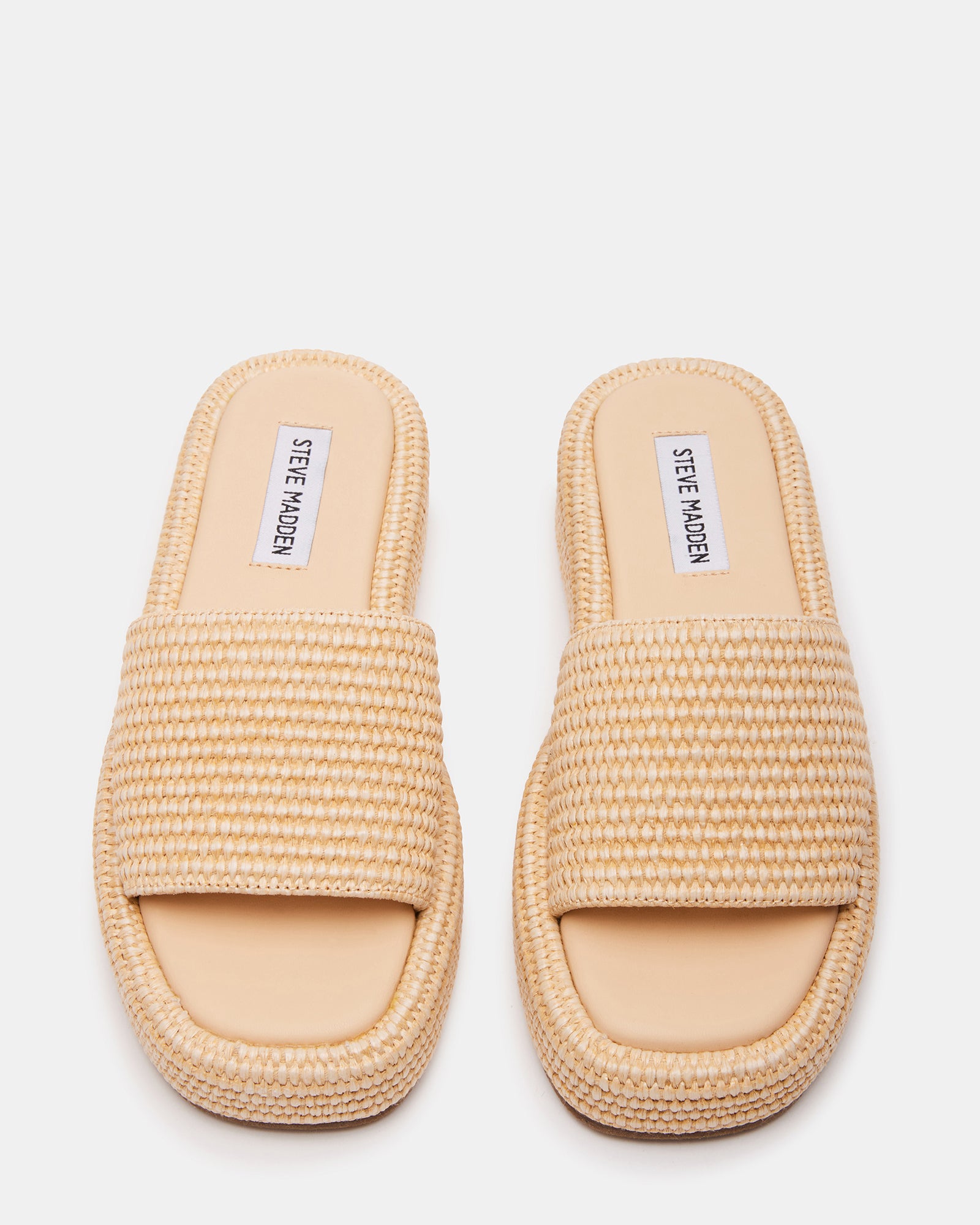 Front view of raffia heeled sandals showing square toe design on wooden deck