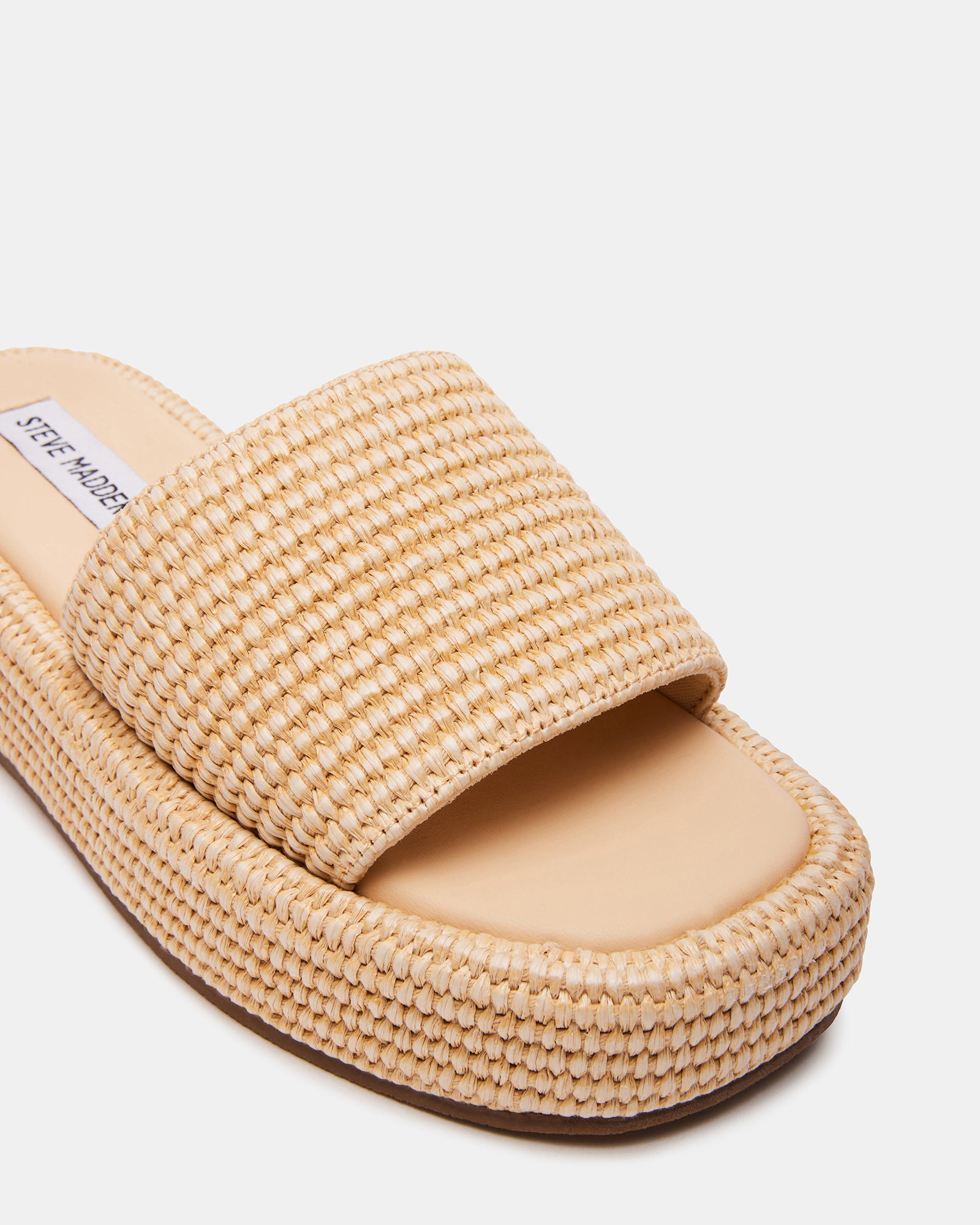 Side angle displaying 1.5" raffia sandals heels and woven texture