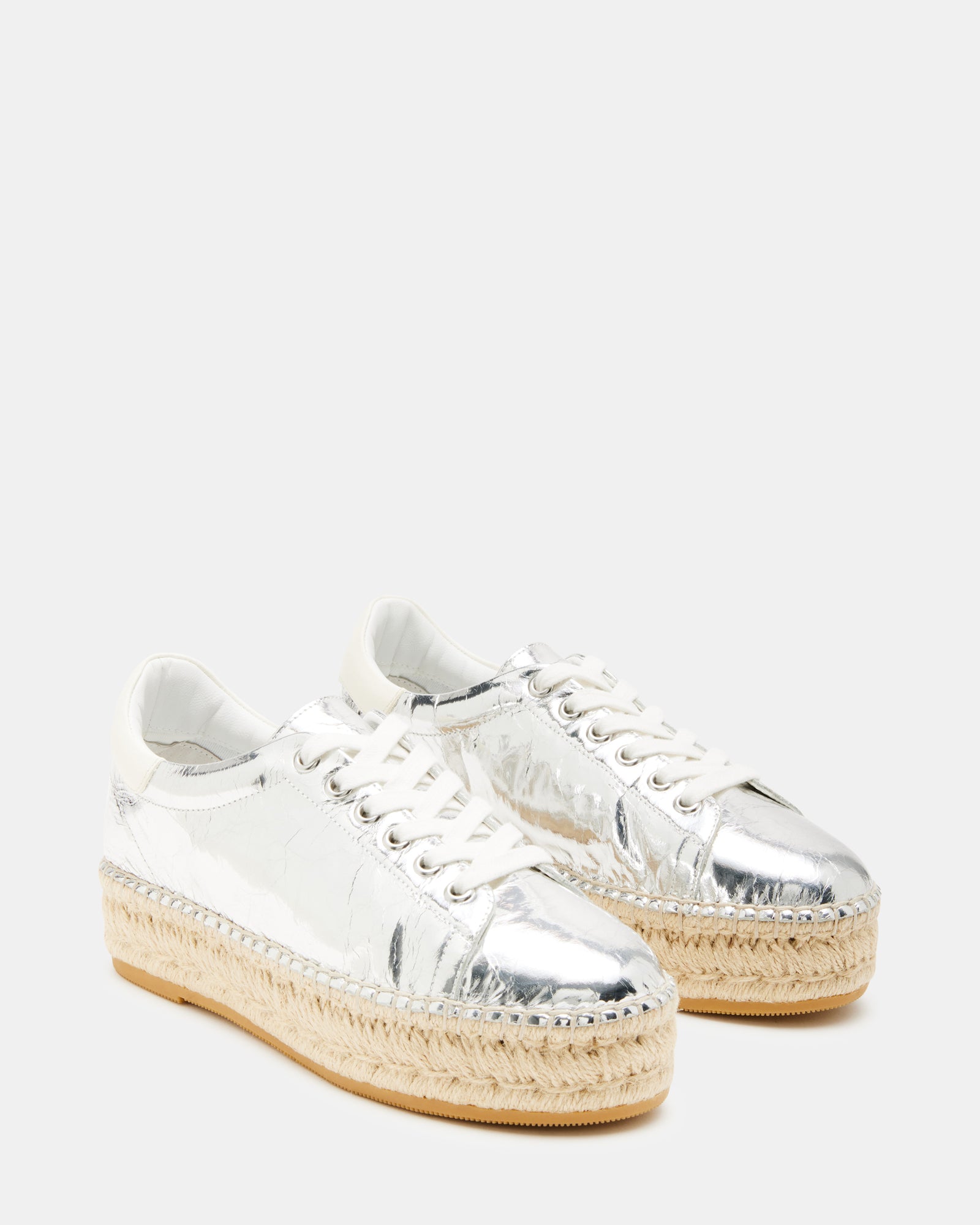 Side view of black platform sneakers showing espadrille wedge detail