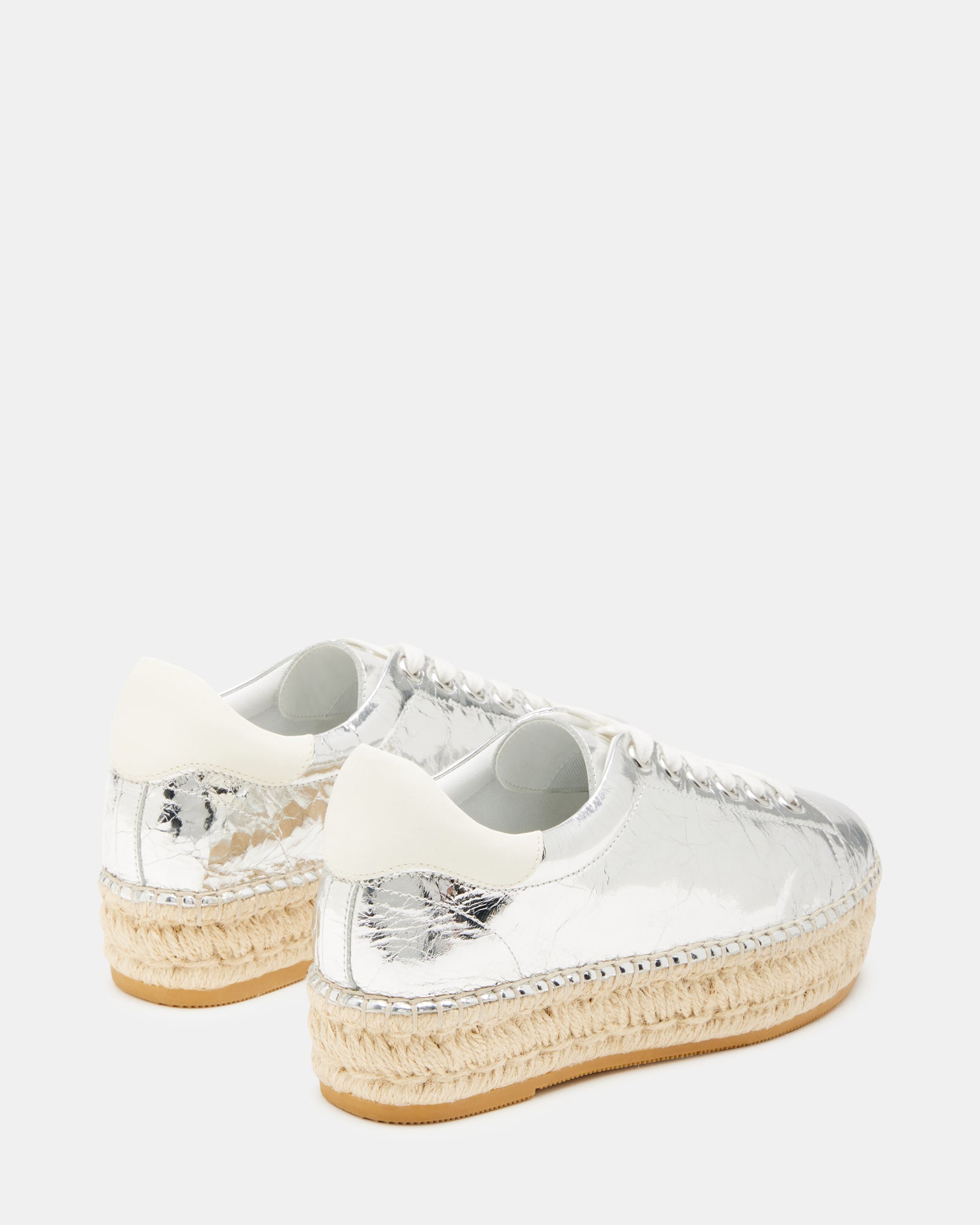 Side view of black platform sneakers showing espadrille wedge detail