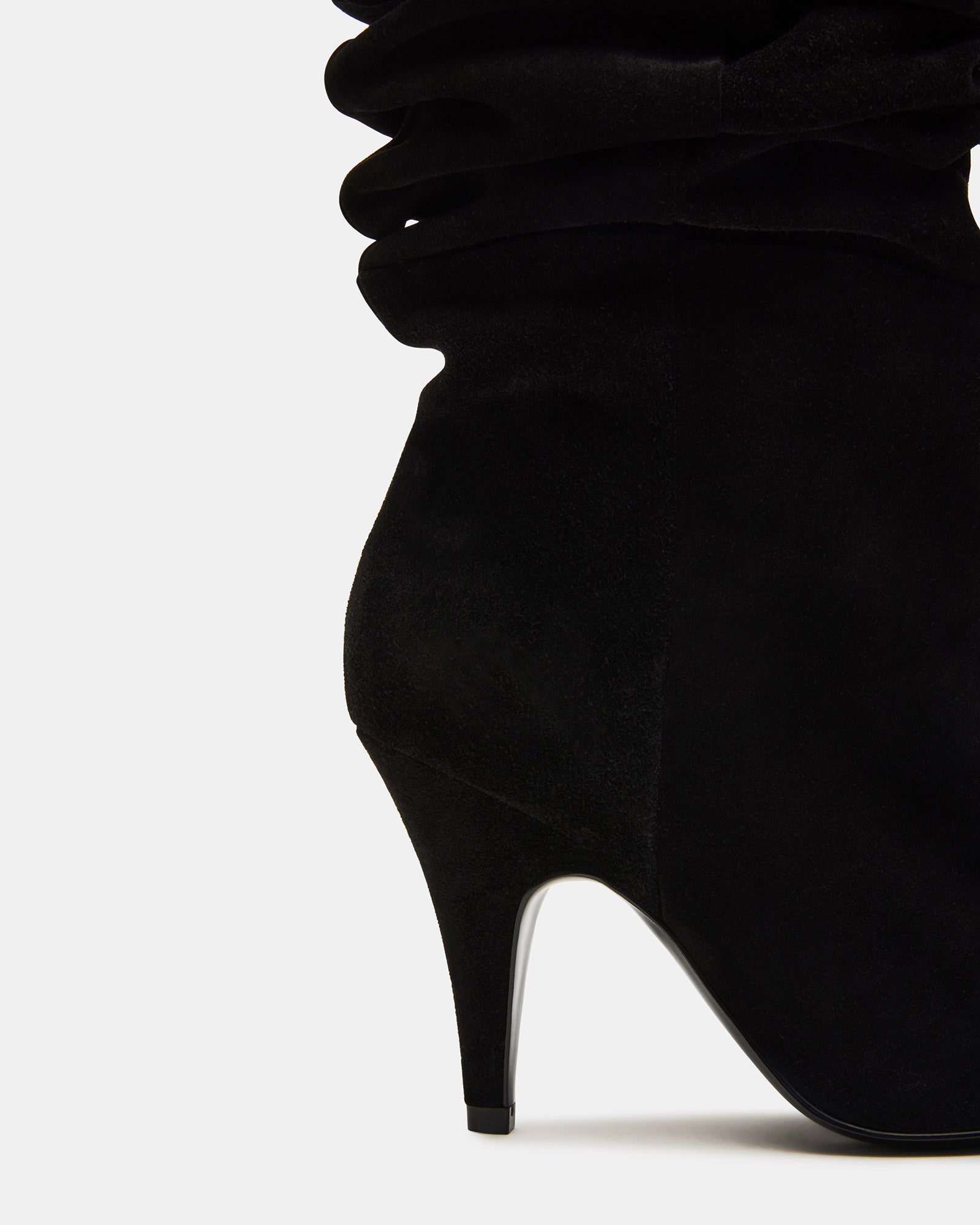 Close-up of black over the knee suede boots styled with skinny jeans