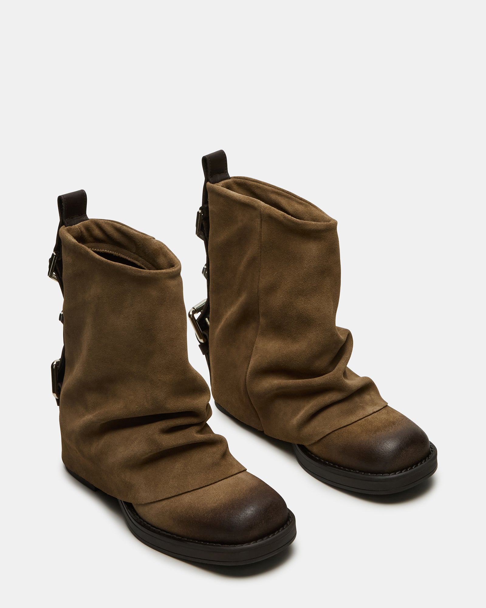 Close-up of the buckle detail on the brown suede booties