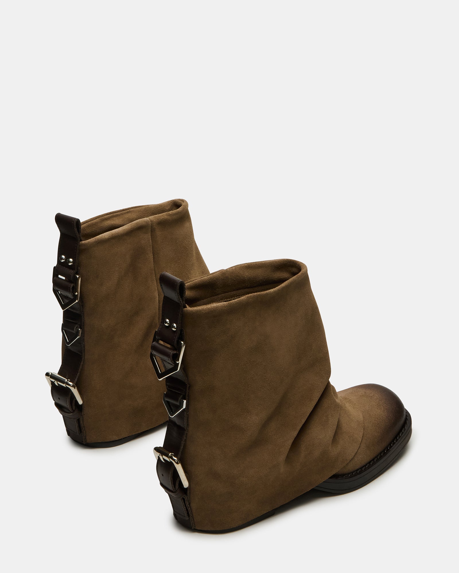 Close-up of the buckle detail on the brown suede booties