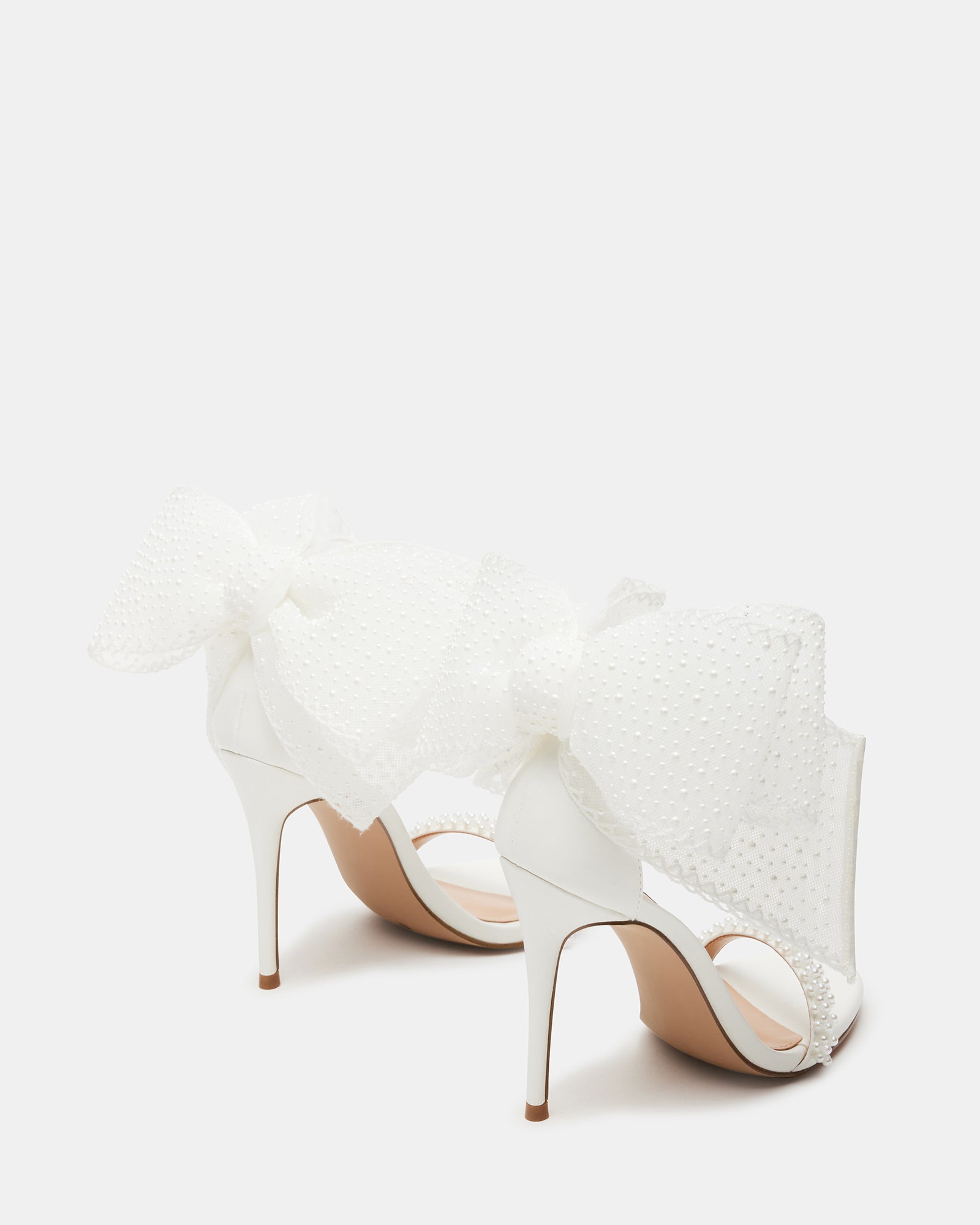 Close-up of BENNI stiletto heels showcasing pearl and bow detailing