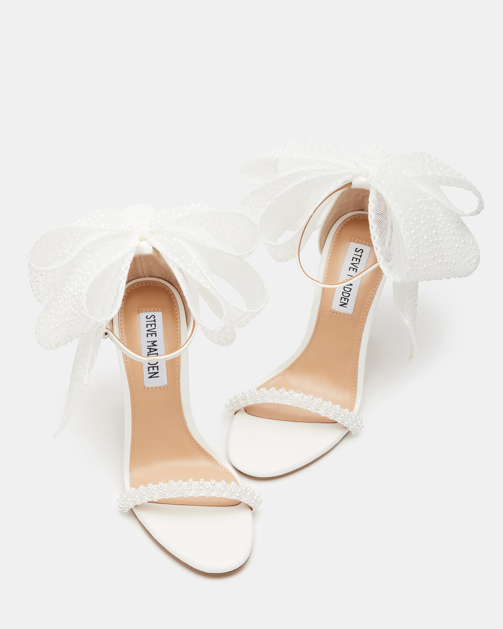 Close-up of BENNI stiletto heels showcasing pearl and bow detailing