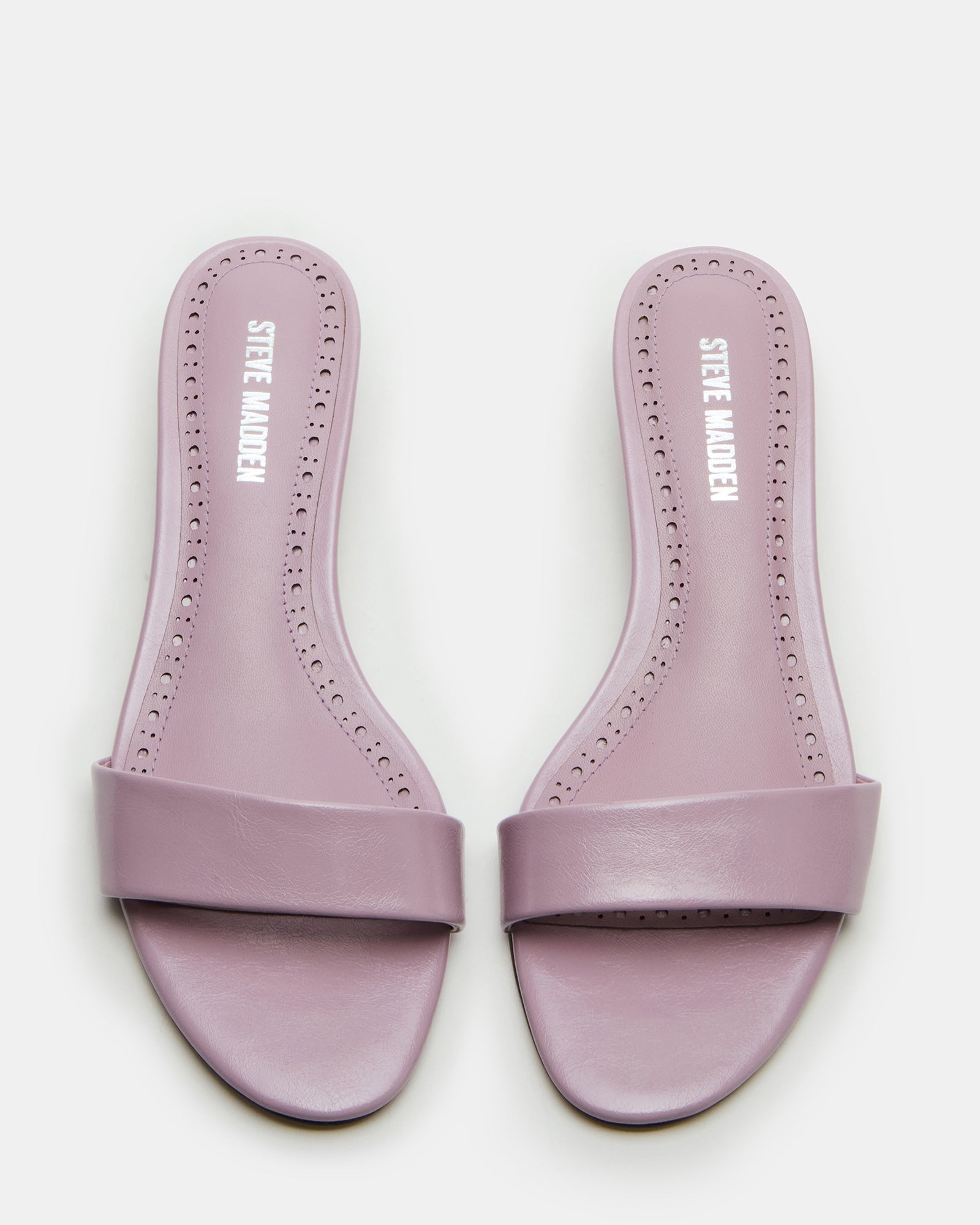 Front angle of blush kitten heel sandals styled with spring attire