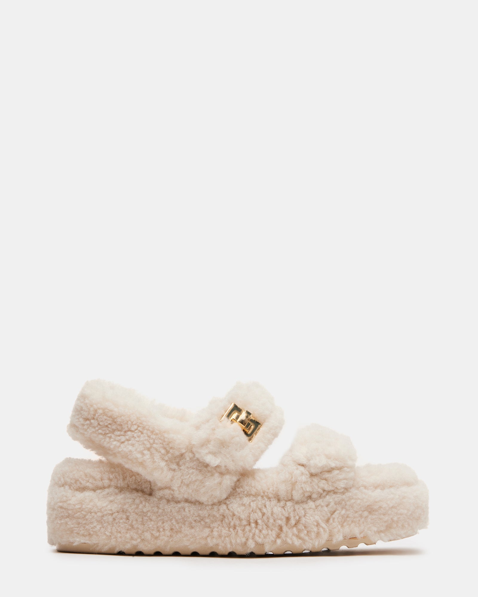 Angled view of flatform sandals showing chunky sole and shearling details