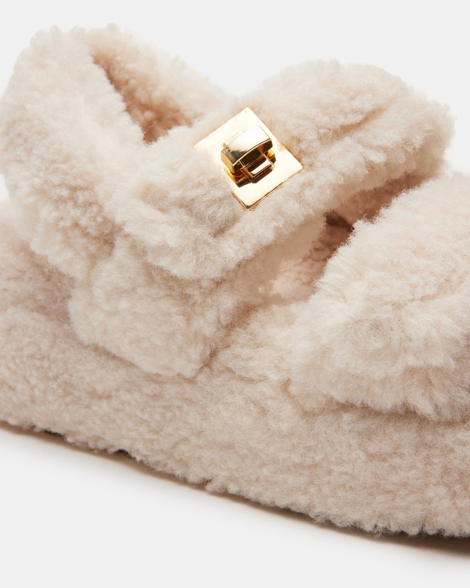 Angled view of flatform sandals showing chunky sole and shearling details