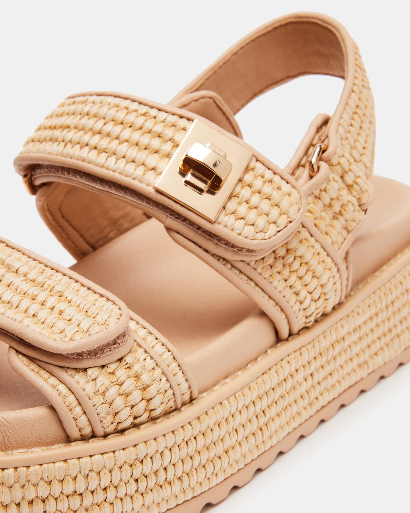 Top-down view of kids flatform sandal with velcro straps and elastic slingback, placed on a picnic blanket