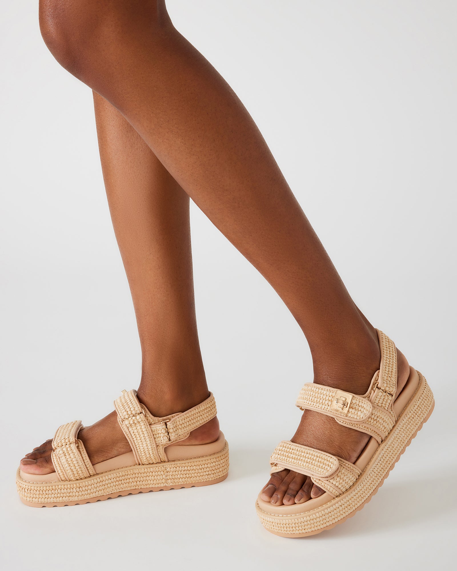 Side view of stylish raffia sandals showing flatform design