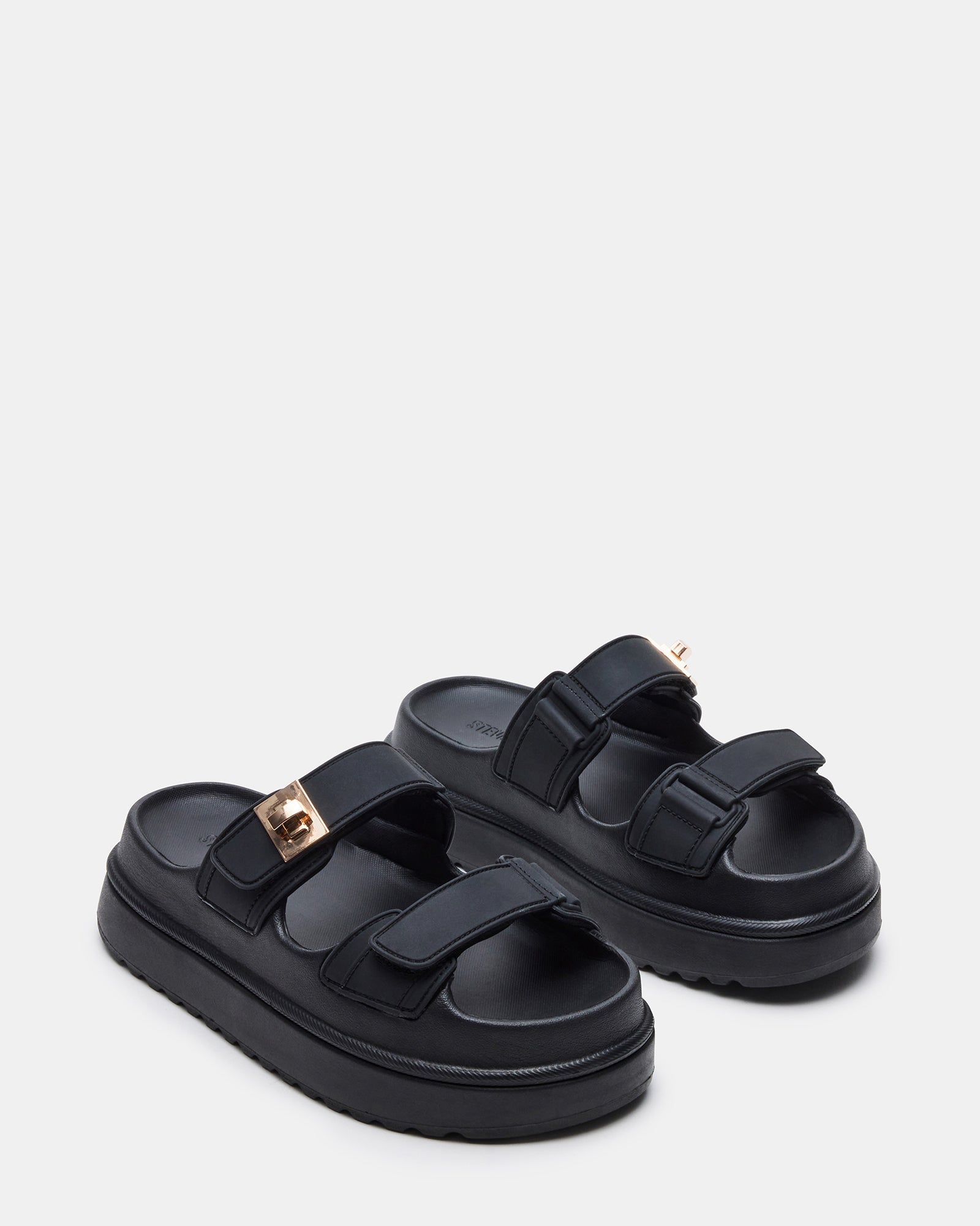 Woman wearing black platform sandals with a summer outfit