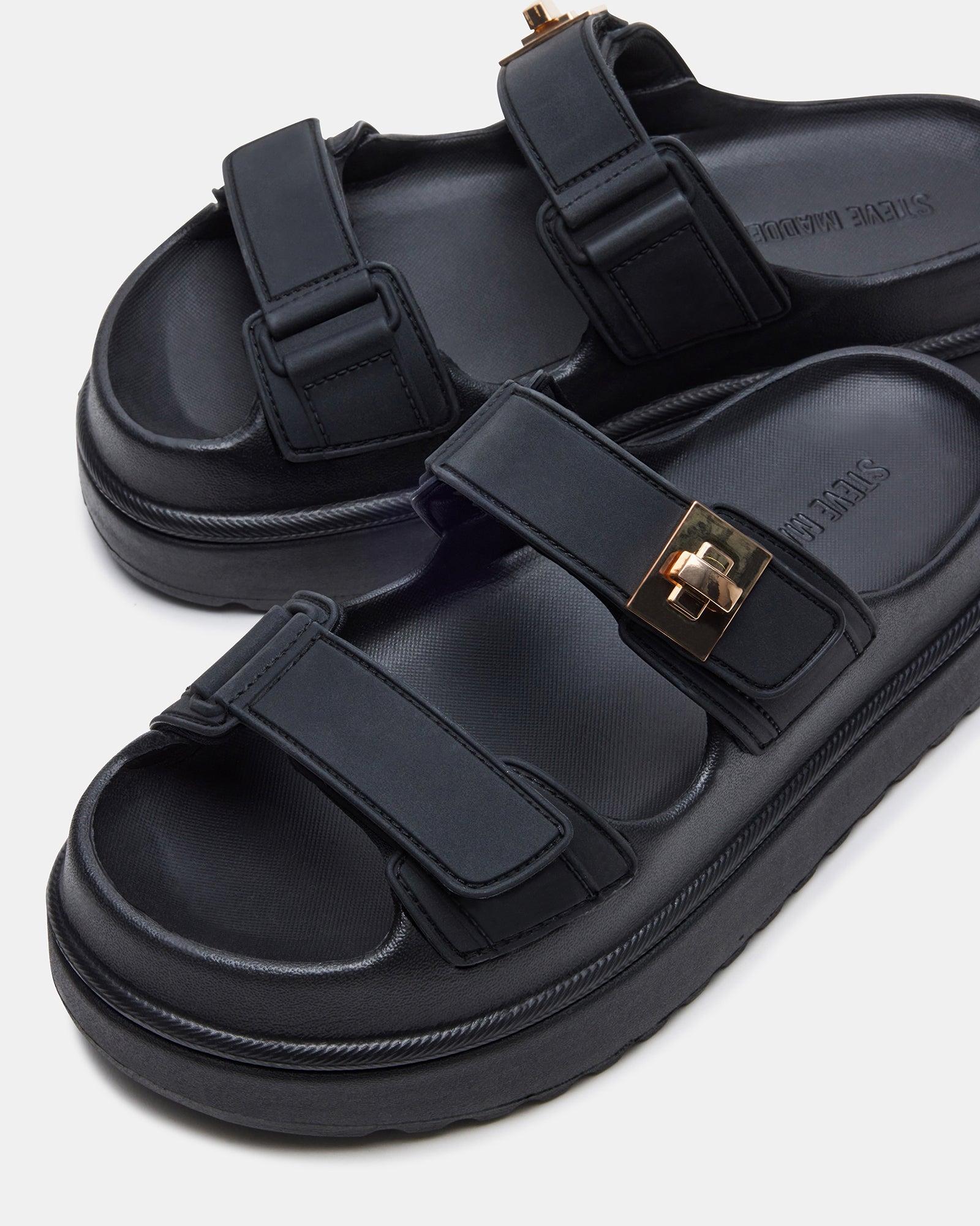 Close-up of BIGSCHMONA black platform sandals with turn-lock hardware