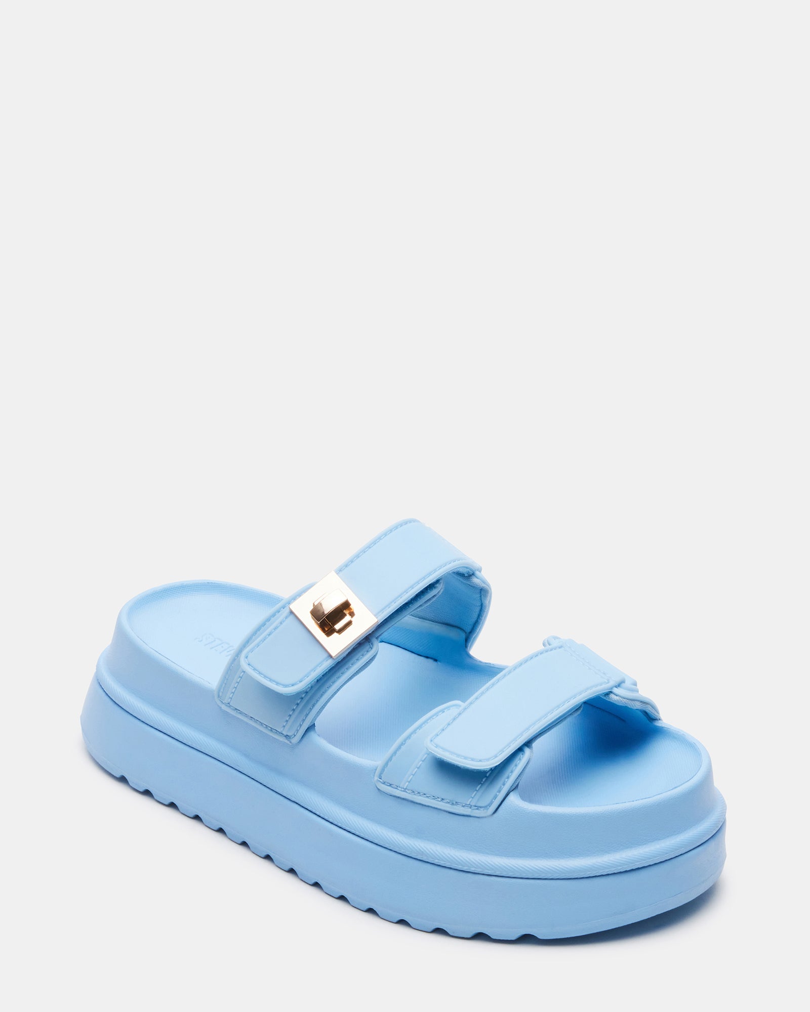 Model wearing light blue jelly platform sandals at a casual event.