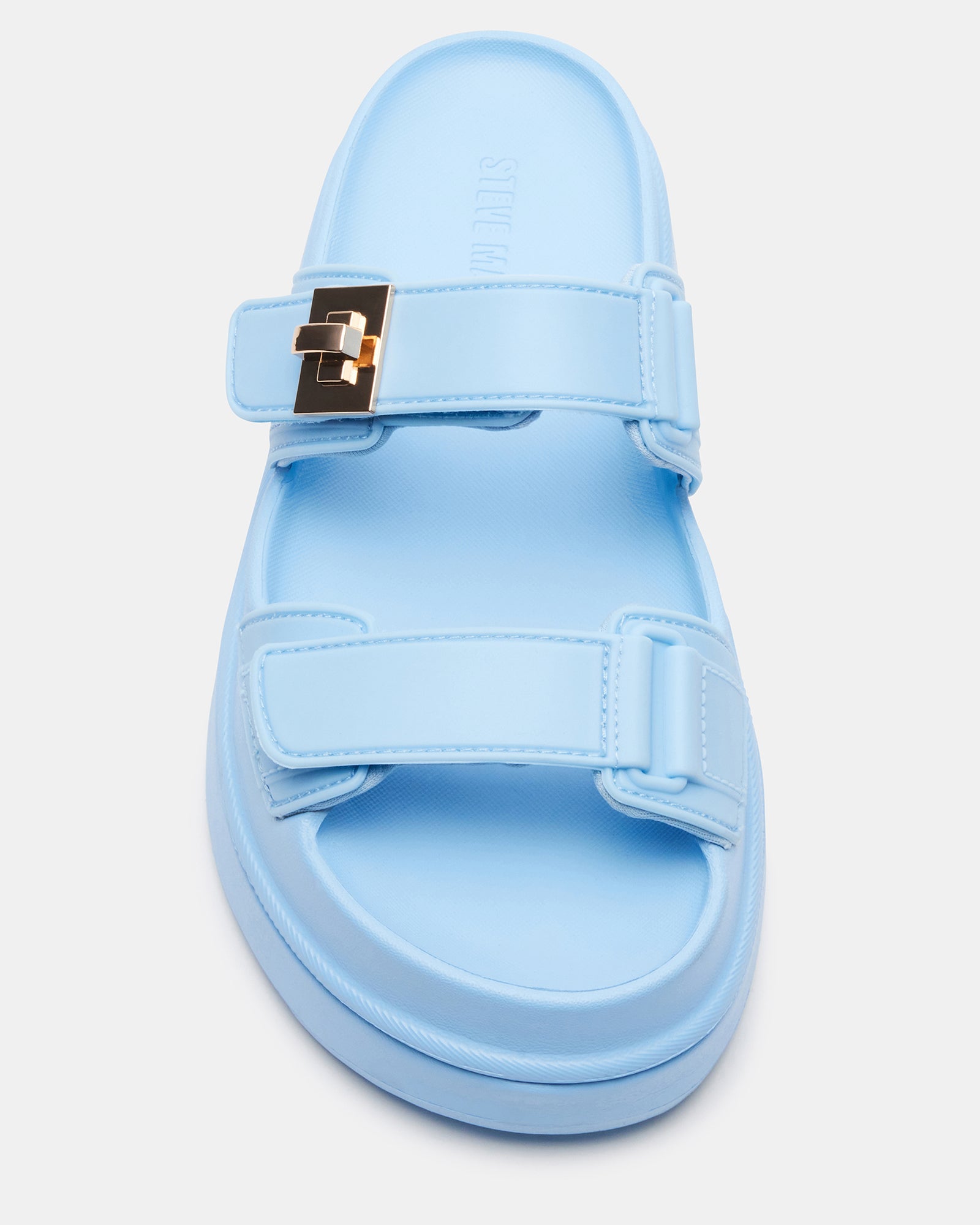 Close-up of the turn-lock hardware on the light blue sandals.