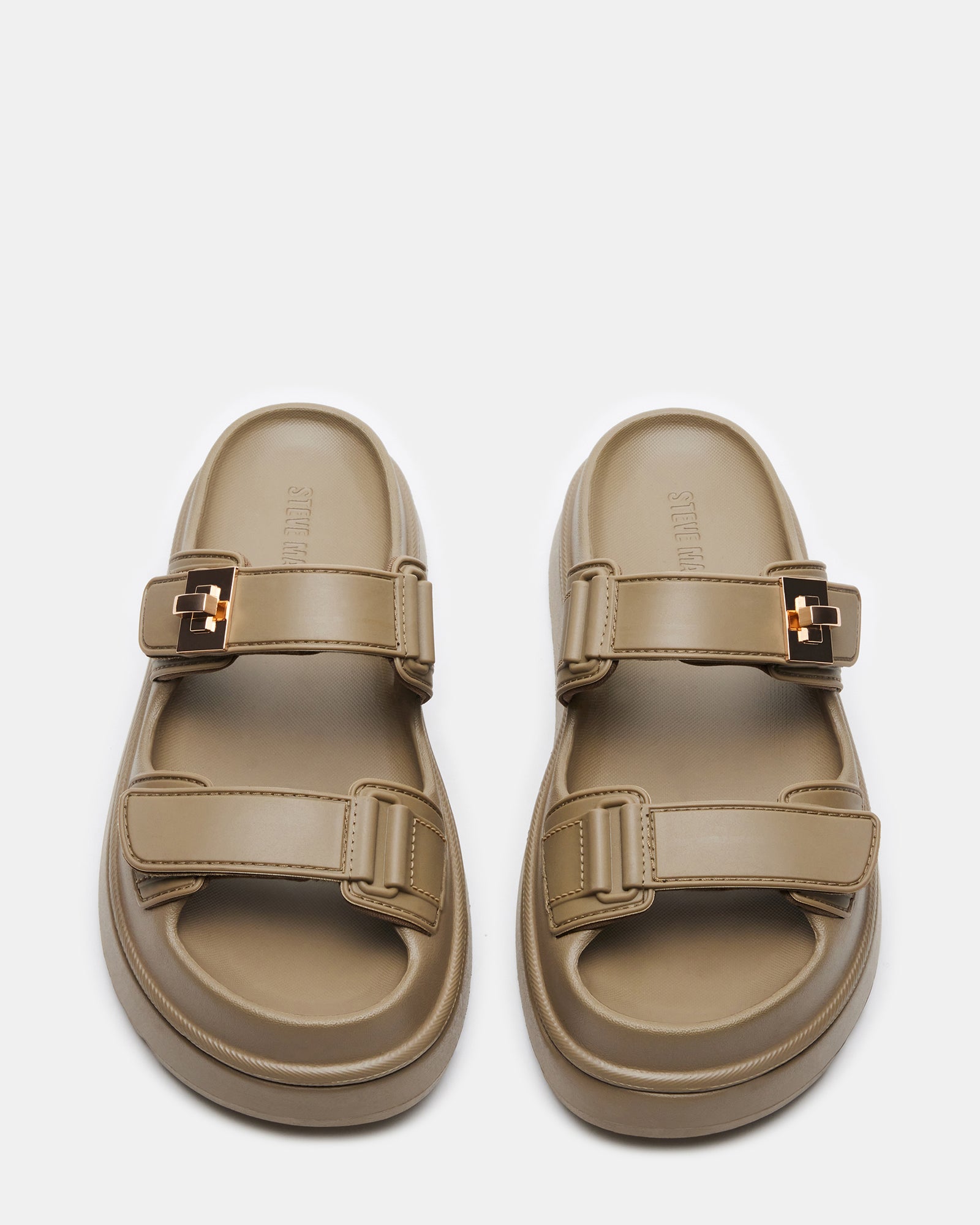 Top-down view of slide sandals with turn-lock accent on synthetic upper