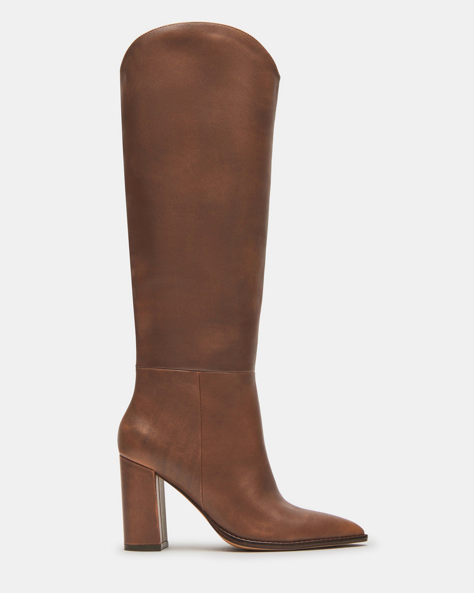 Side view of BIXBY brown distressed leather knee boots showcasing pointed toe and block heel.