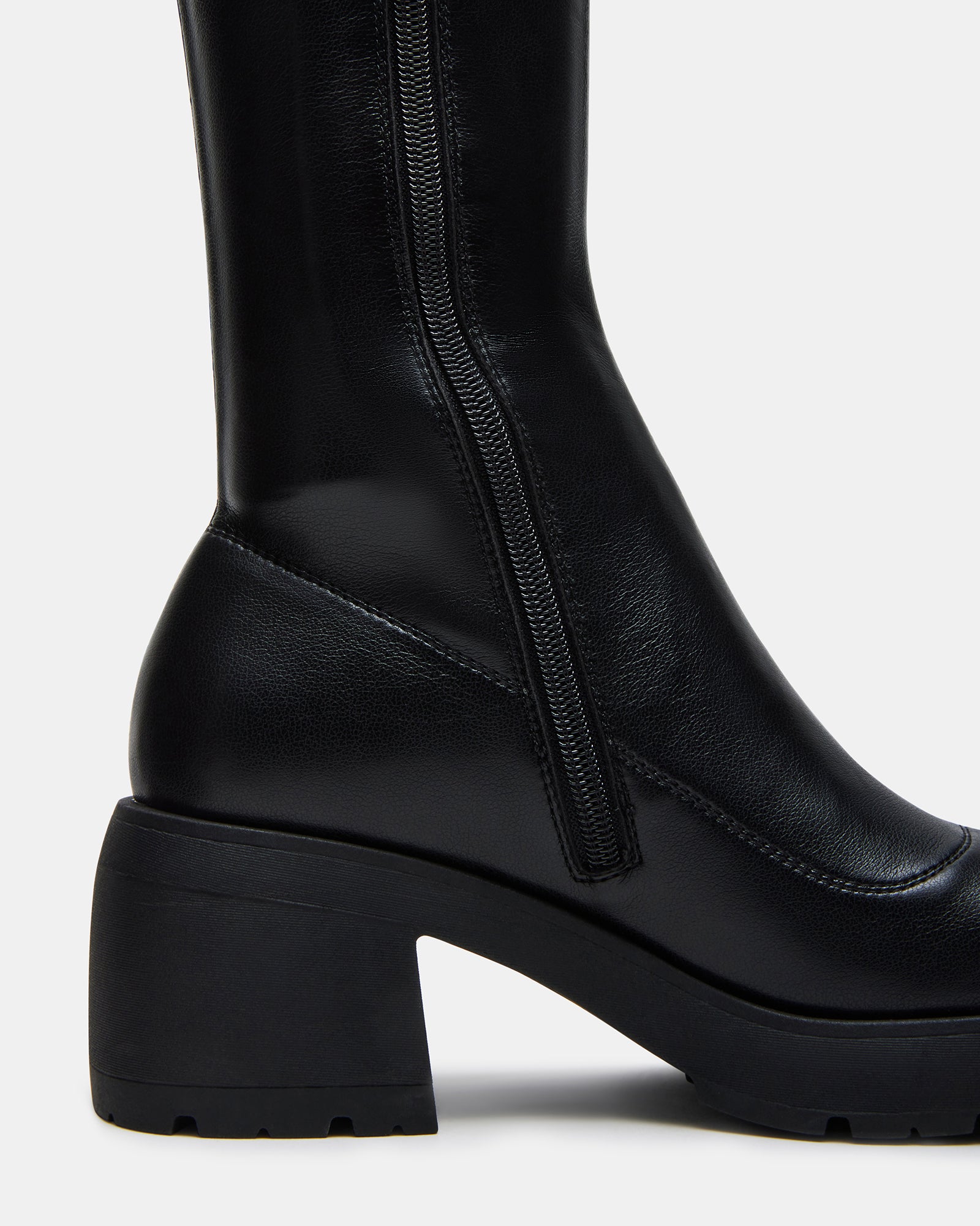 Wide calf over the knee boots paired with a layered coat for cool-weather style.