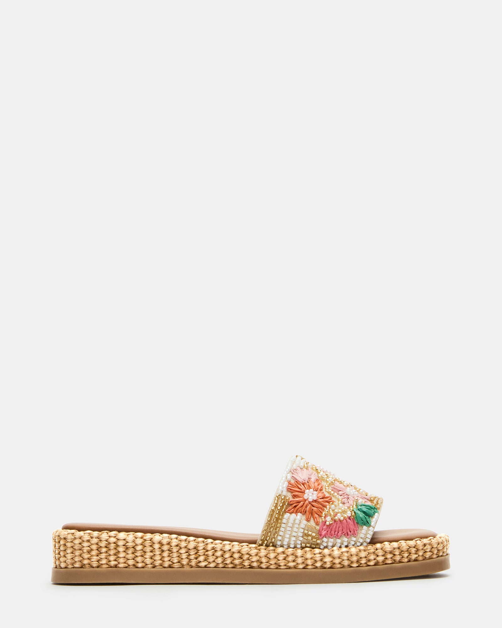 Side view of chic raffia flatform slide sandals on a sunny day