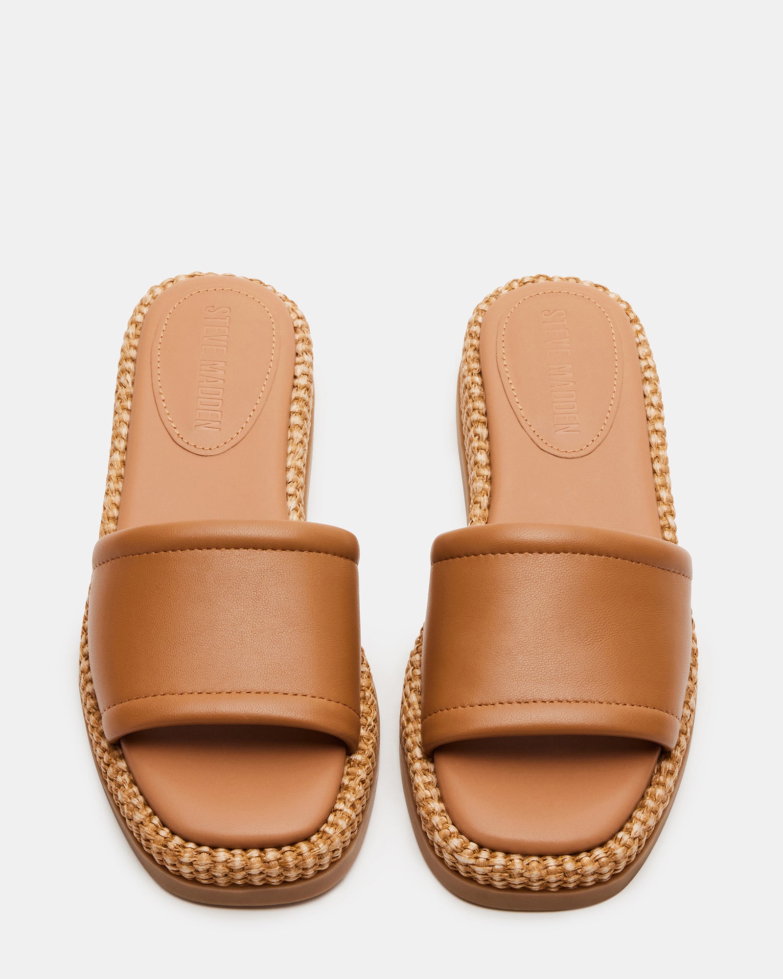 Side view of platform sandals styled with summer outfit on outdoor patio
