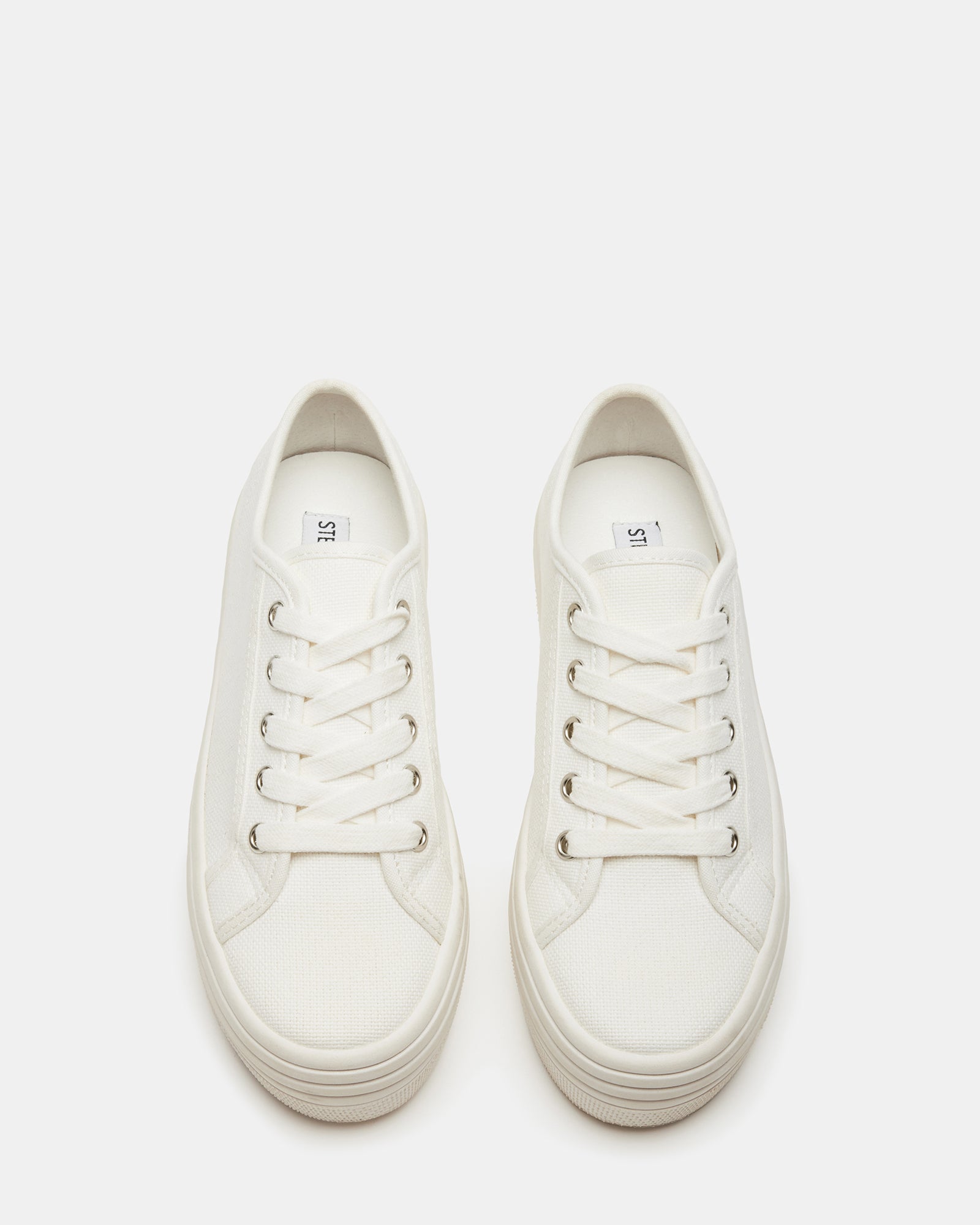Bobbi 30 white platform sandals worn with a denim jacket