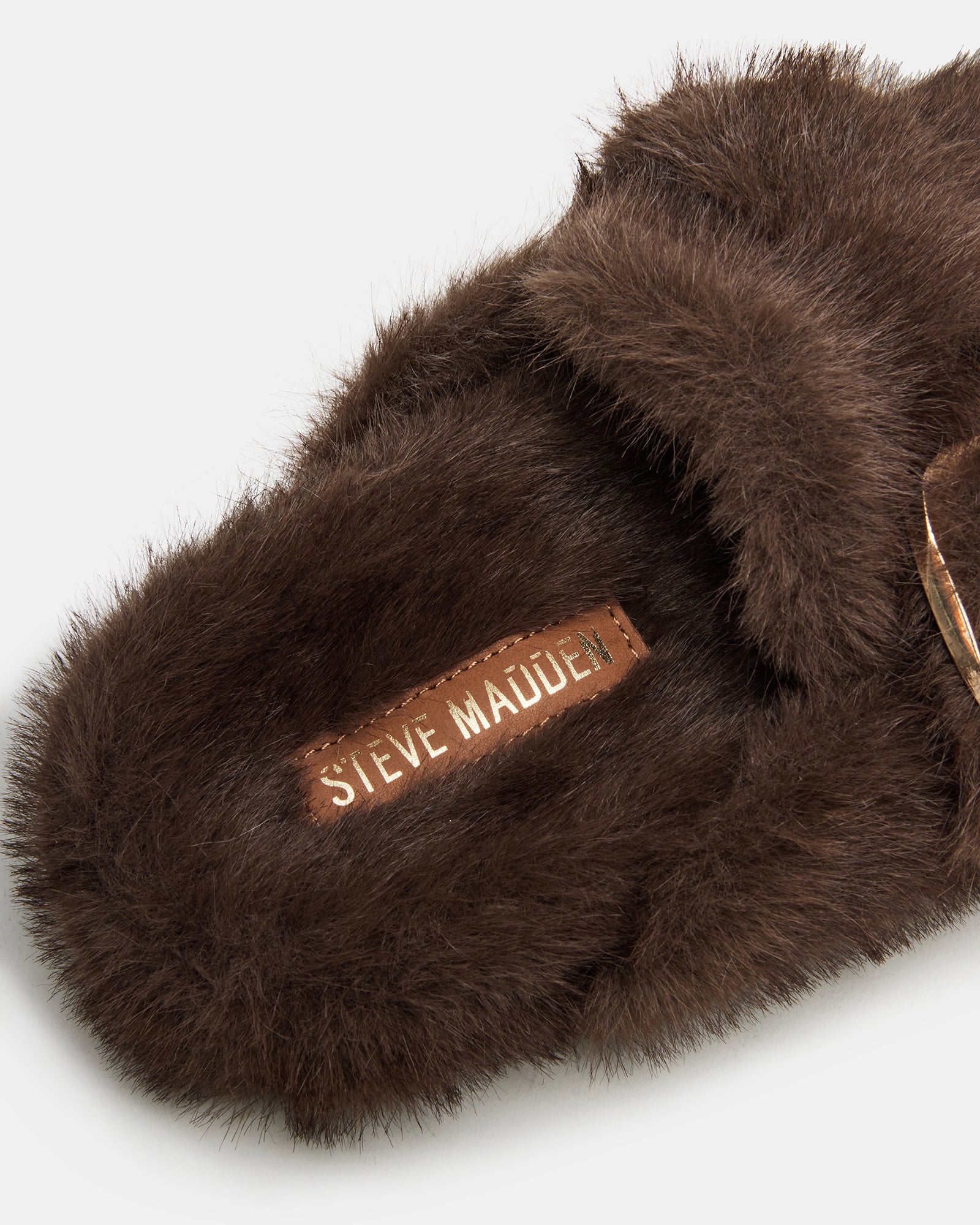 Bohan Brown faux fur slip-on shoes displayed on a wooden bench