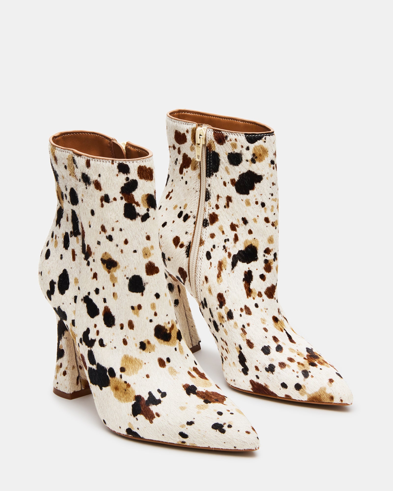 Side view showing the zip closure and textured cow print leather