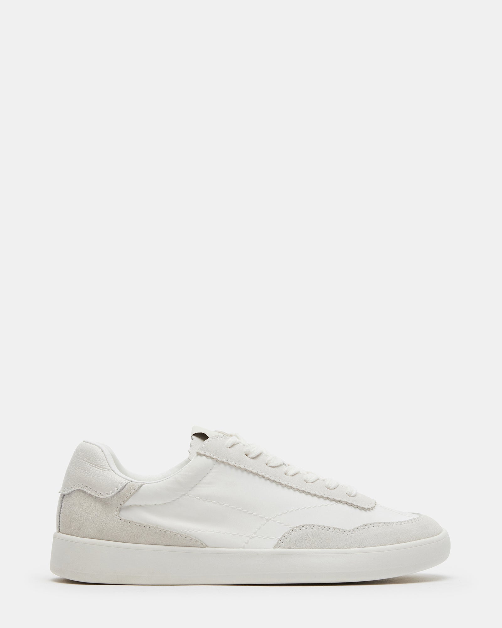 Braxton white leather sneakers on a stylish urban background.