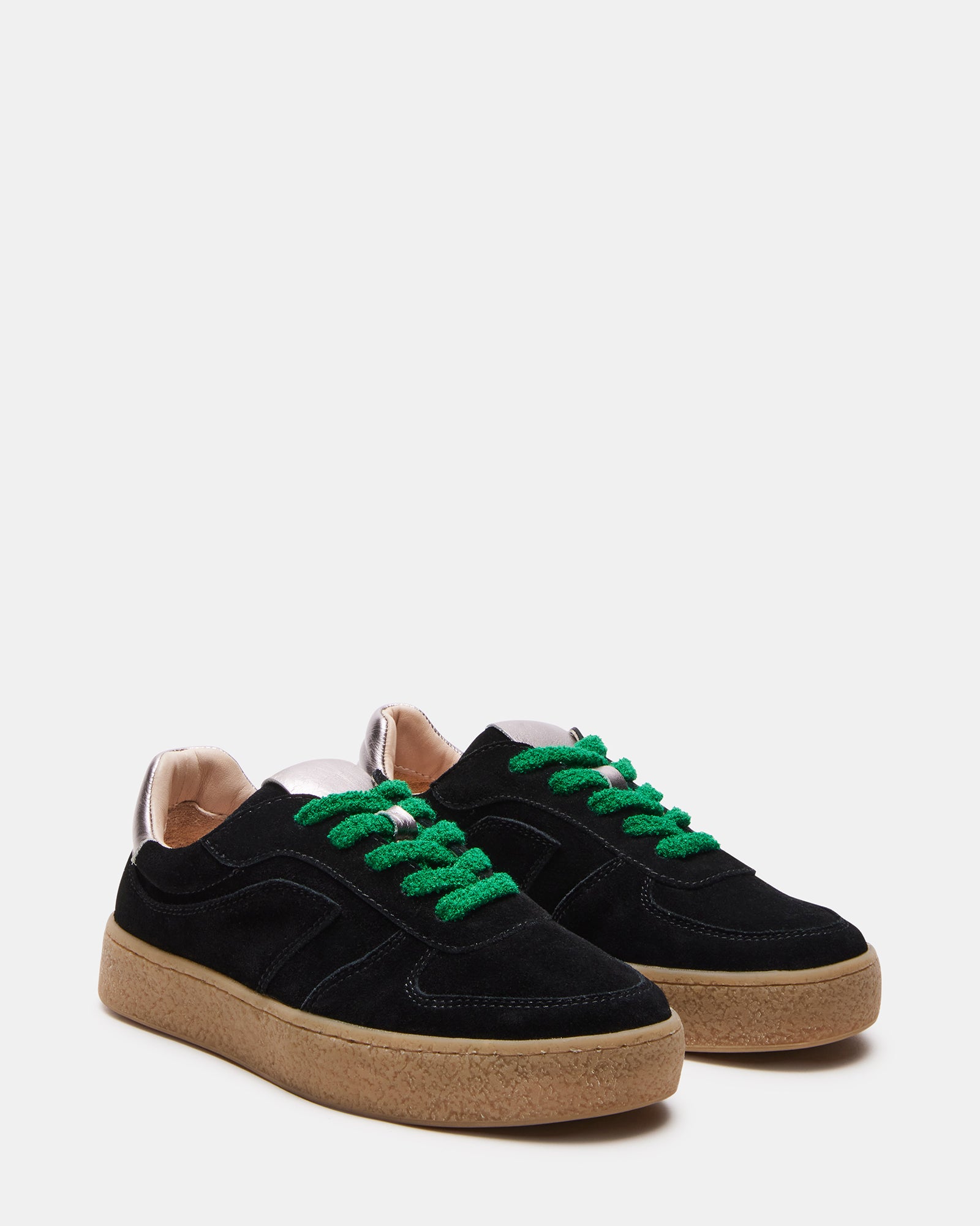 Side view of low-top sneakers highlighting perforated details and fuzzy laces